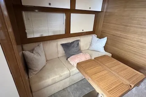  Yacht Photos Pics Interior of 2013 Uniesse 49 EXPRESS yacht with cozy seating and wooden table.