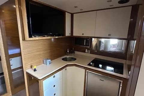  Yacht Photos Pics Modern kitchen interior of 2013 Uniesse 49 EXPRESS yacht with sleek cabinetry and appliances.