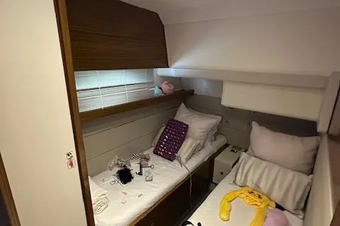  Yacht Photos Pics Cozy cabin interior of 2013 Uniesse 49 EXPRESS yacht with twin beds and soft lighting.