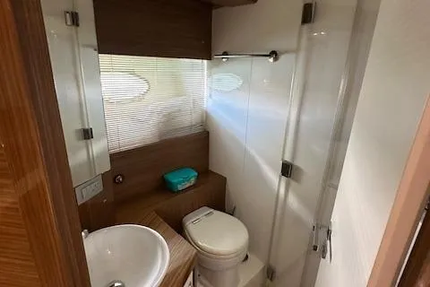  Yacht Photos Pics Bathroom interior of 2013 Uniesse 49 EXPRESS yacht, featuring modern fixtures and wood accents.