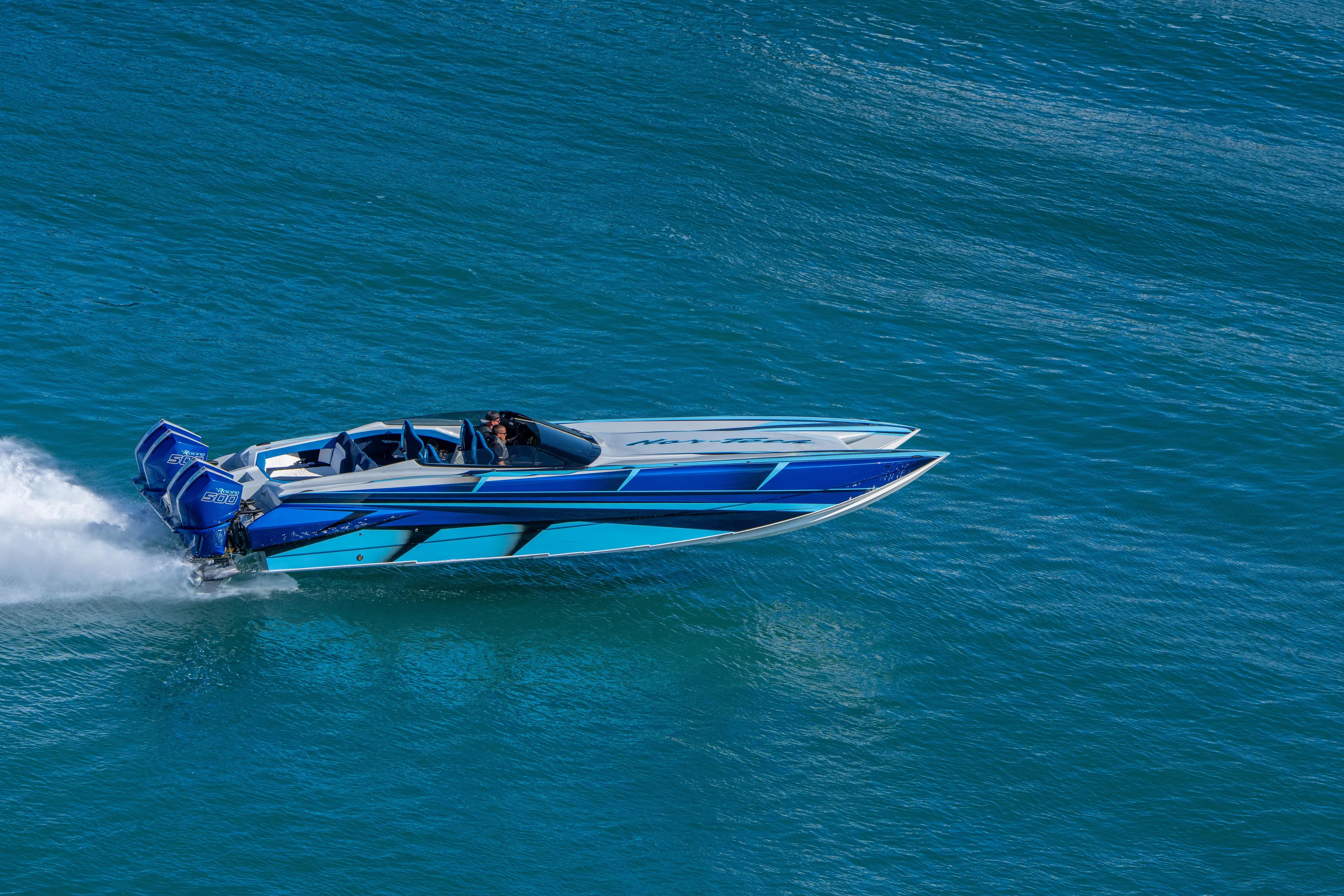  Yacht Photos Pics 2026 Nor-Tech 4000 Super Catamaran speeding on blue ocean waters.