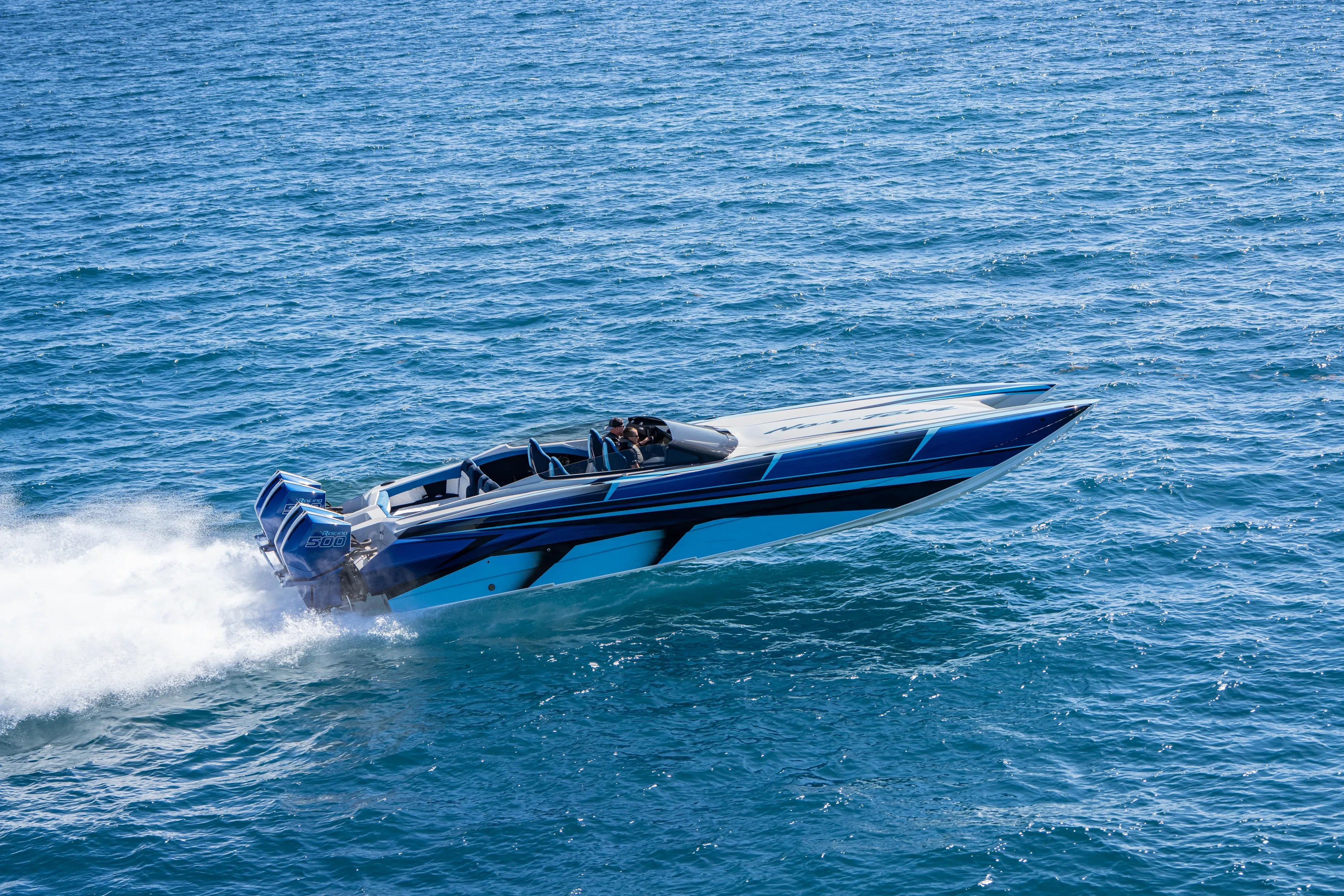  Yacht Photos Pics 2026 Nor-Tech 4000 Super Catamaran speeding on open water, showcasing sleek design.