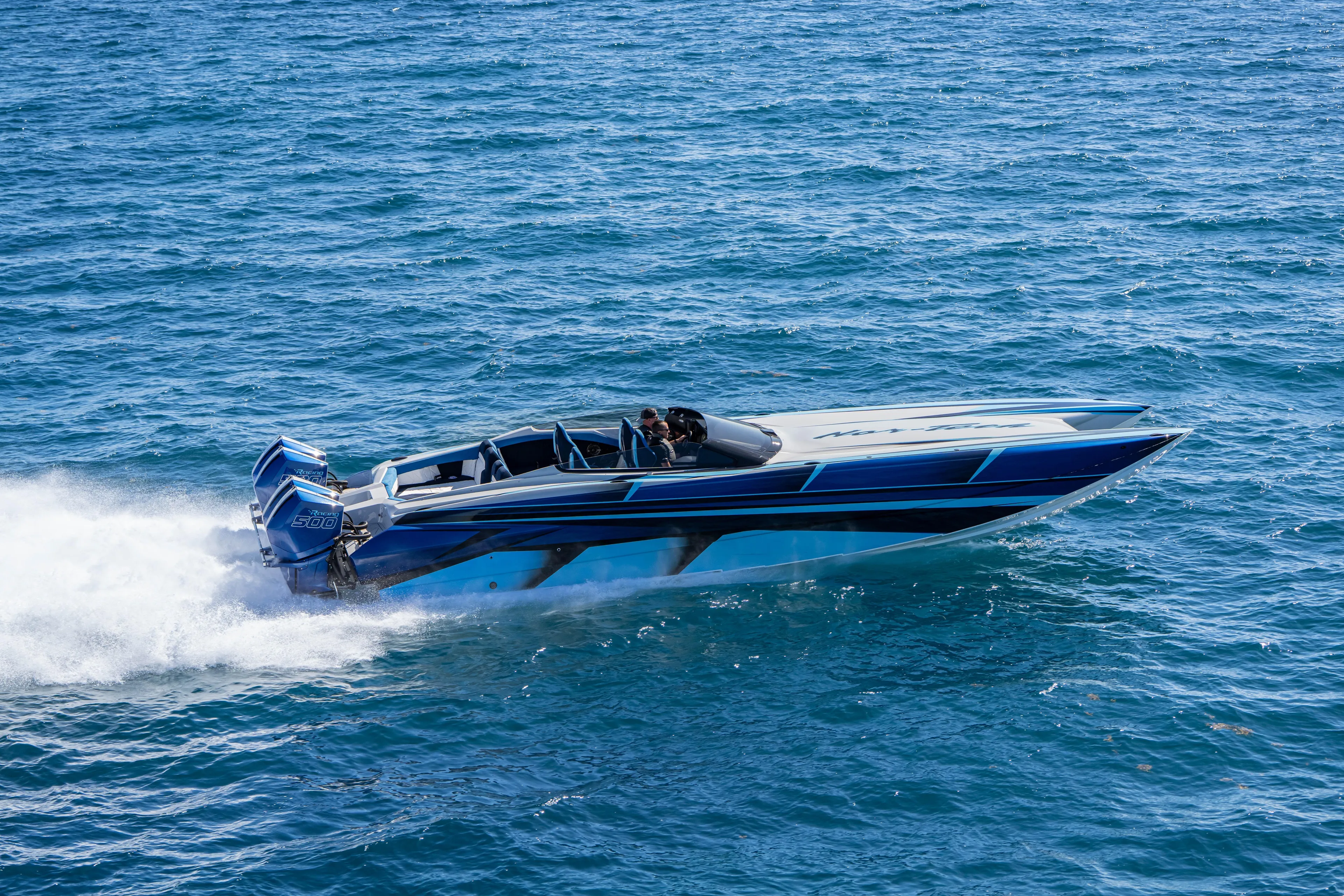  Yacht Photos Pics 2026 Nor-Tech 4000 Super Catamaran speeding on open water, showcasing sleek design and power.