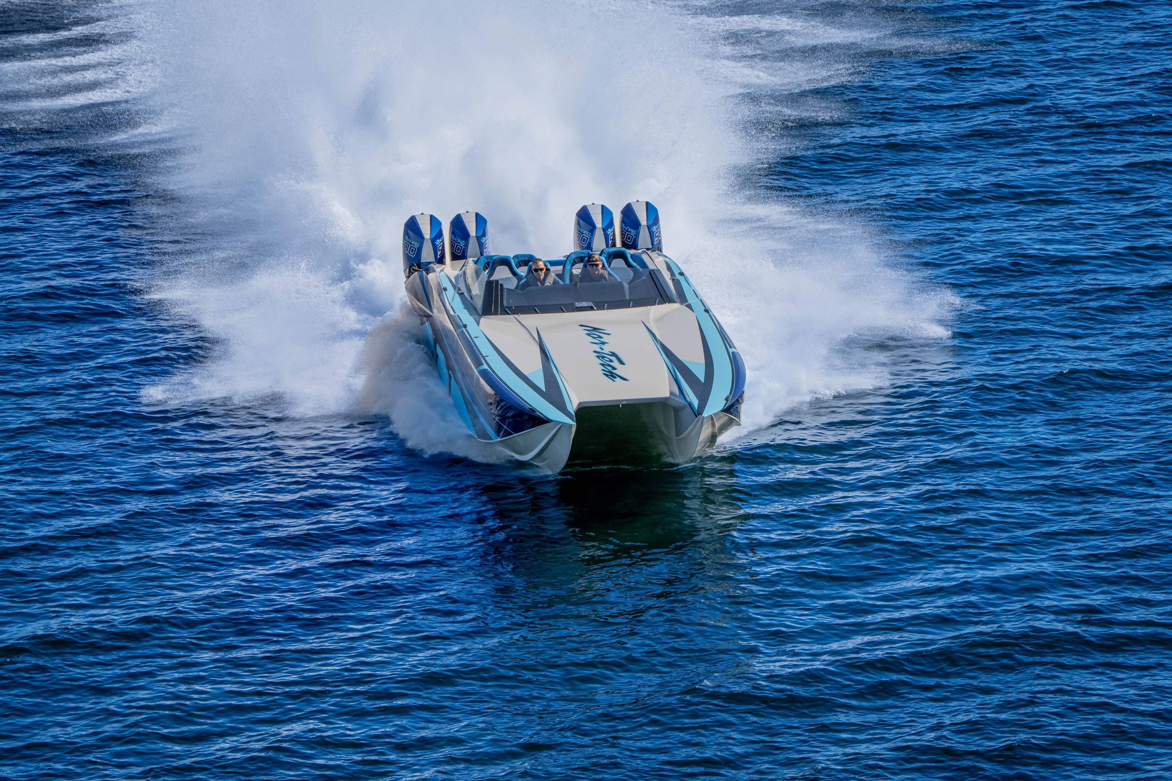  Yacht Photos Pics 2026 Nor-Tech 4000 Super Catamaran speeding on open water, creating a dramatic wake.