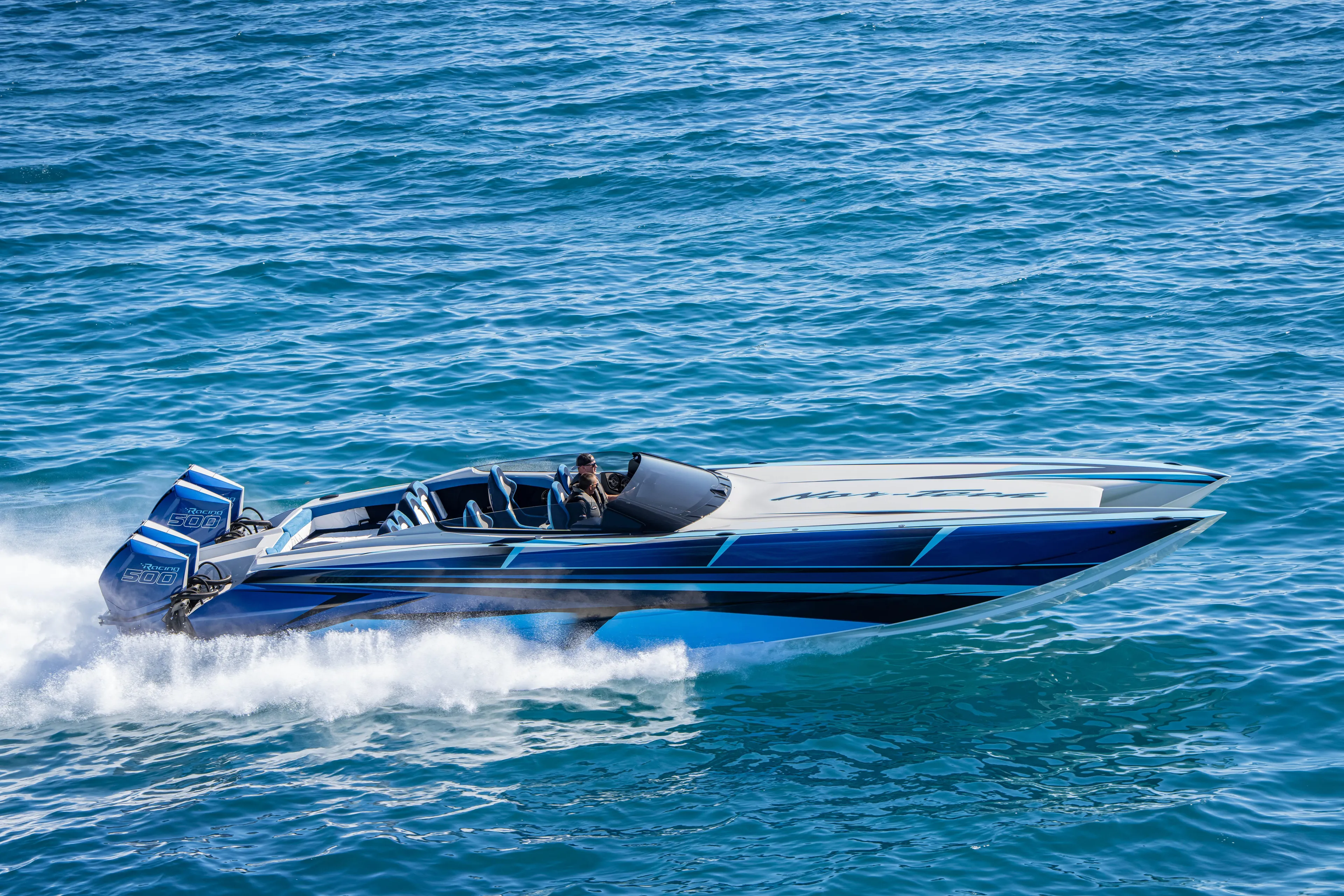  Yacht Photos Pics 2026 Nor-Tech 4000 Super Catamaran speeding on blue ocean waters.