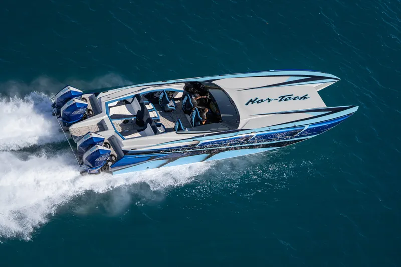  Yacht Photos Pics 2026 Nor-Tech 4000 Super Catamaran speeding on blue ocean waters.