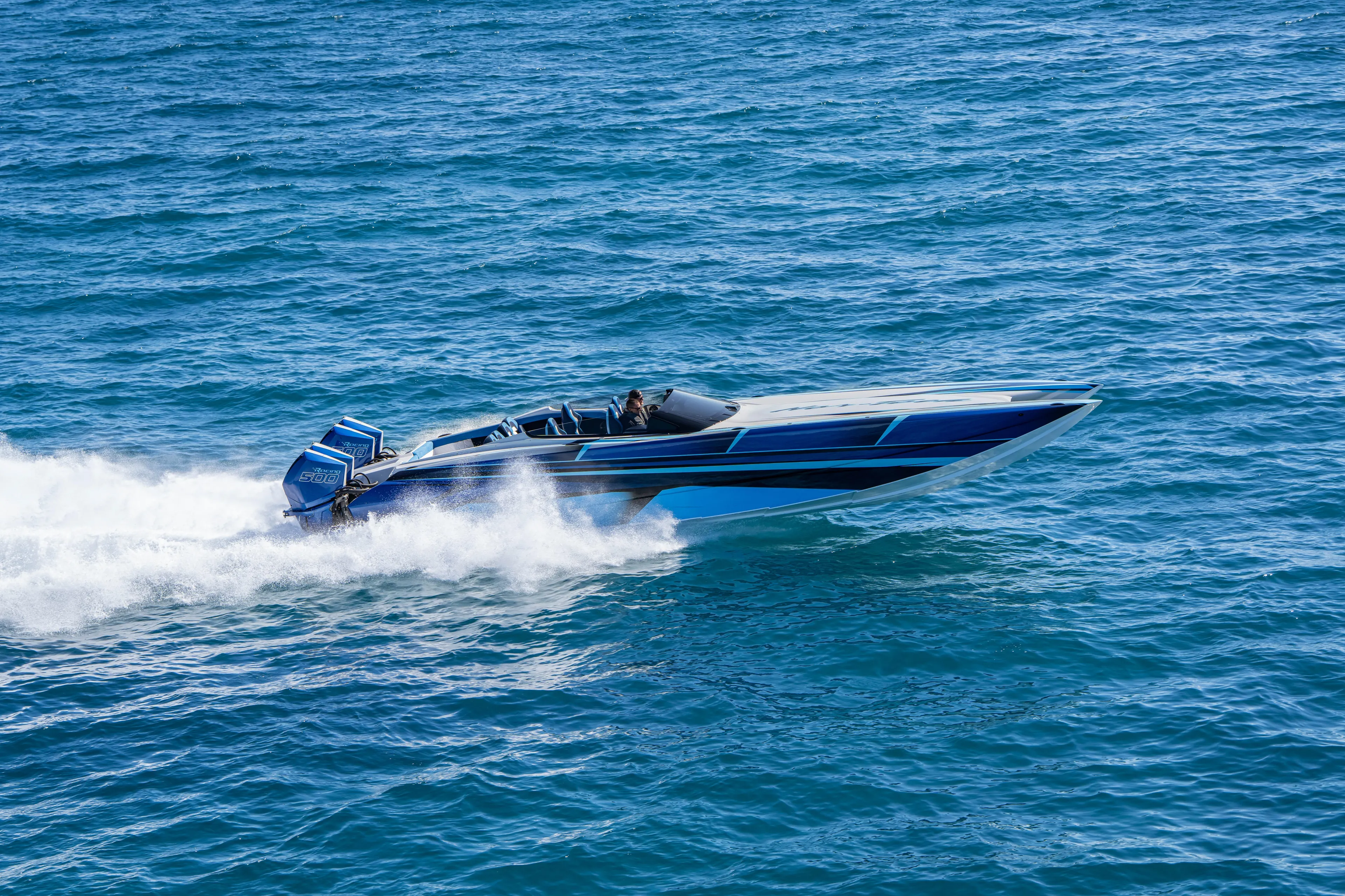 Yacht Photos Pics 2026 Nor-Tech 4000 Super Catamaran speeding on open water, showcasing sleek design and power.
