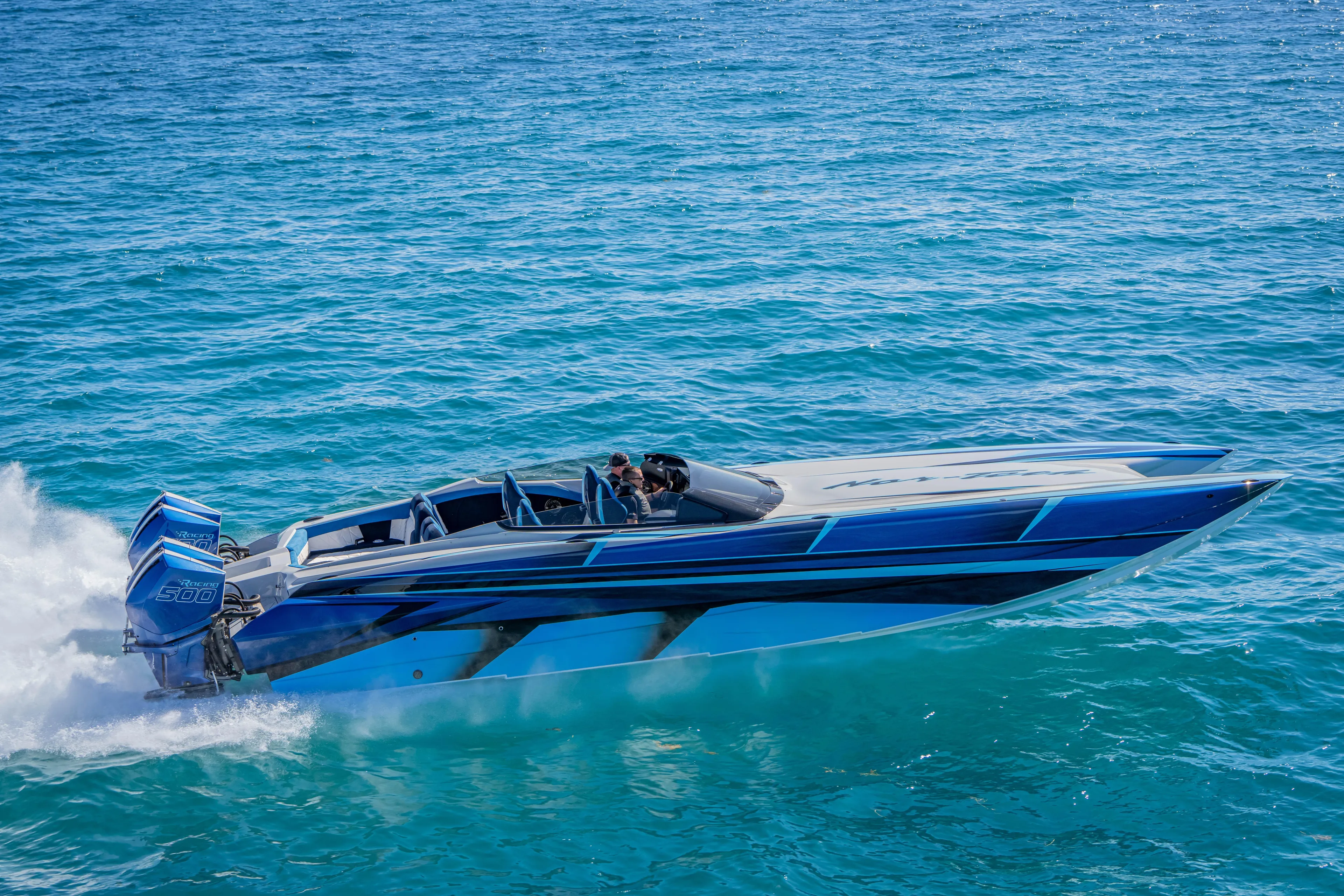  Yacht Photos Pics 2026 Nor-Tech 4000 Super Catamaran speeding on clear blue ocean waters.