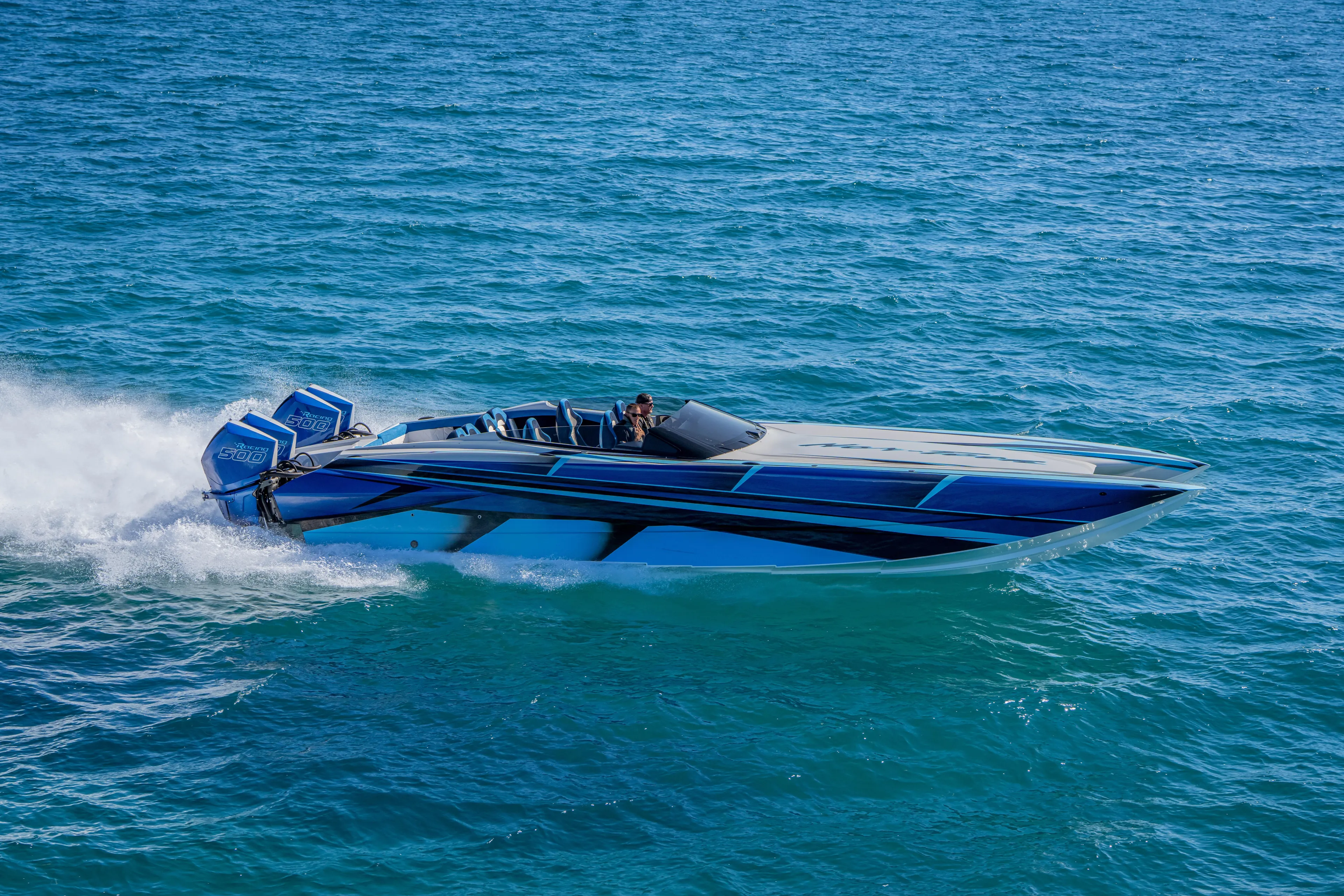  Yacht Photos Pics 2026 Nor-Tech 4000 Super Catamaran speeding on open water, showcasing sleek design.