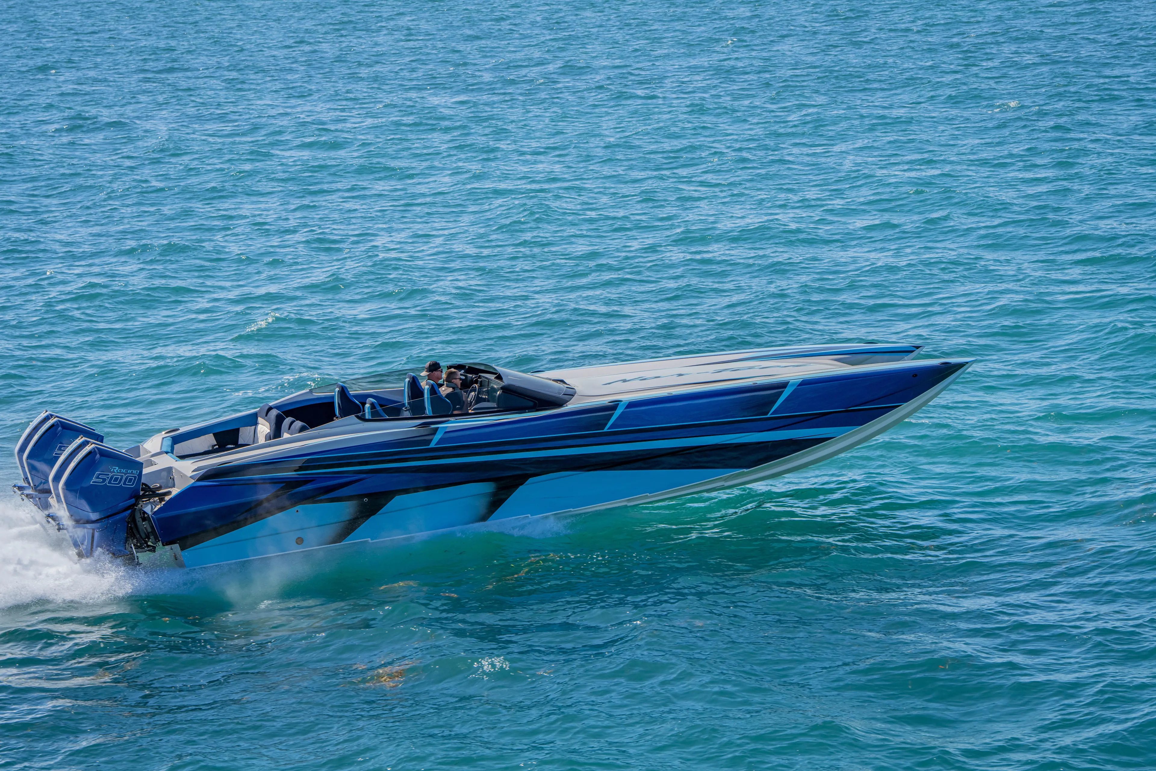  Yacht Photos Pics 2026 Nor-Tech 4000 Super Catamaran speeding on open water, showcasing sleek design and power.