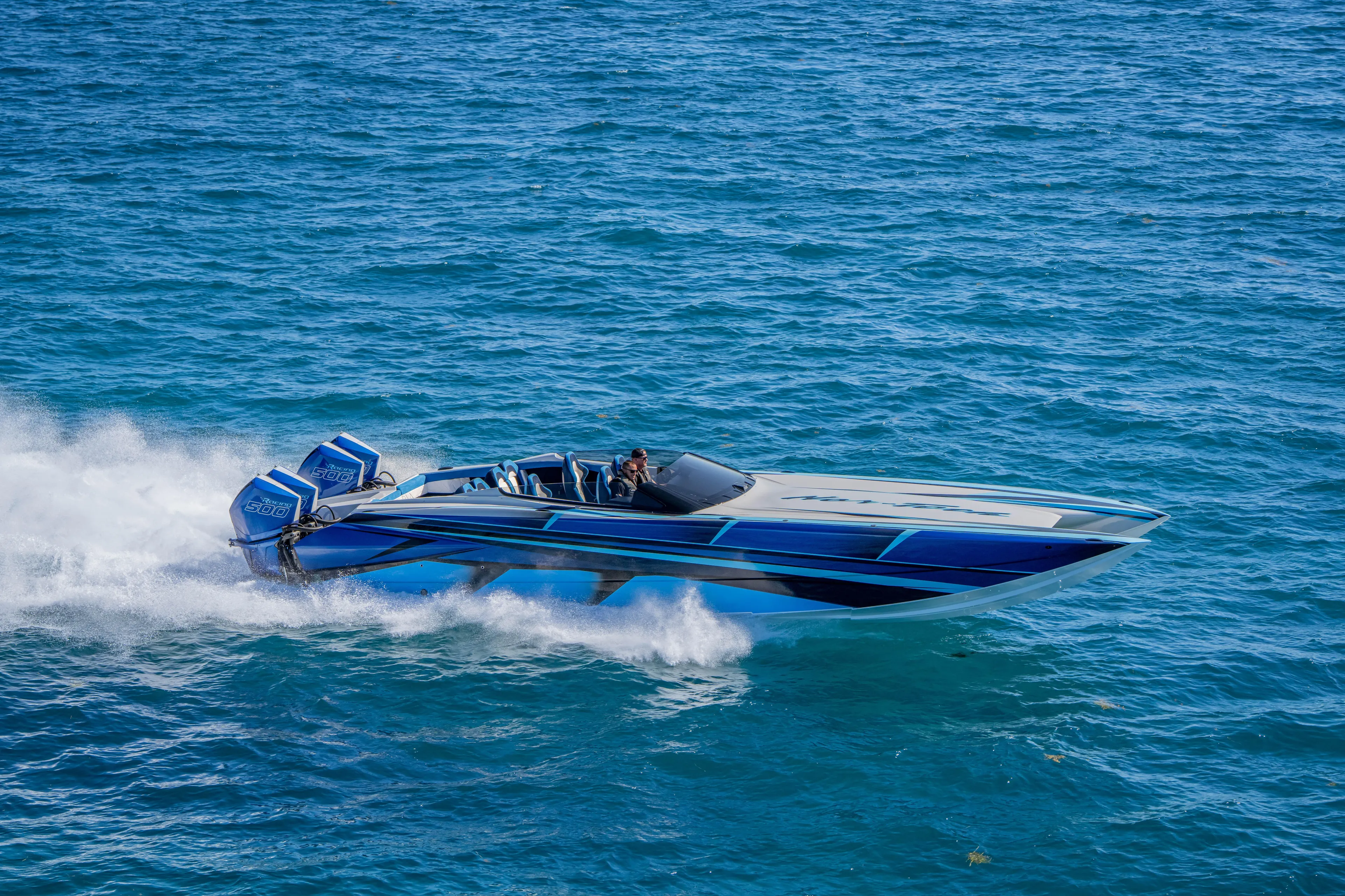  Yacht Photos Pics 2026 Nor-Tech 4000 Super Catamaran speeding on blue ocean waters.