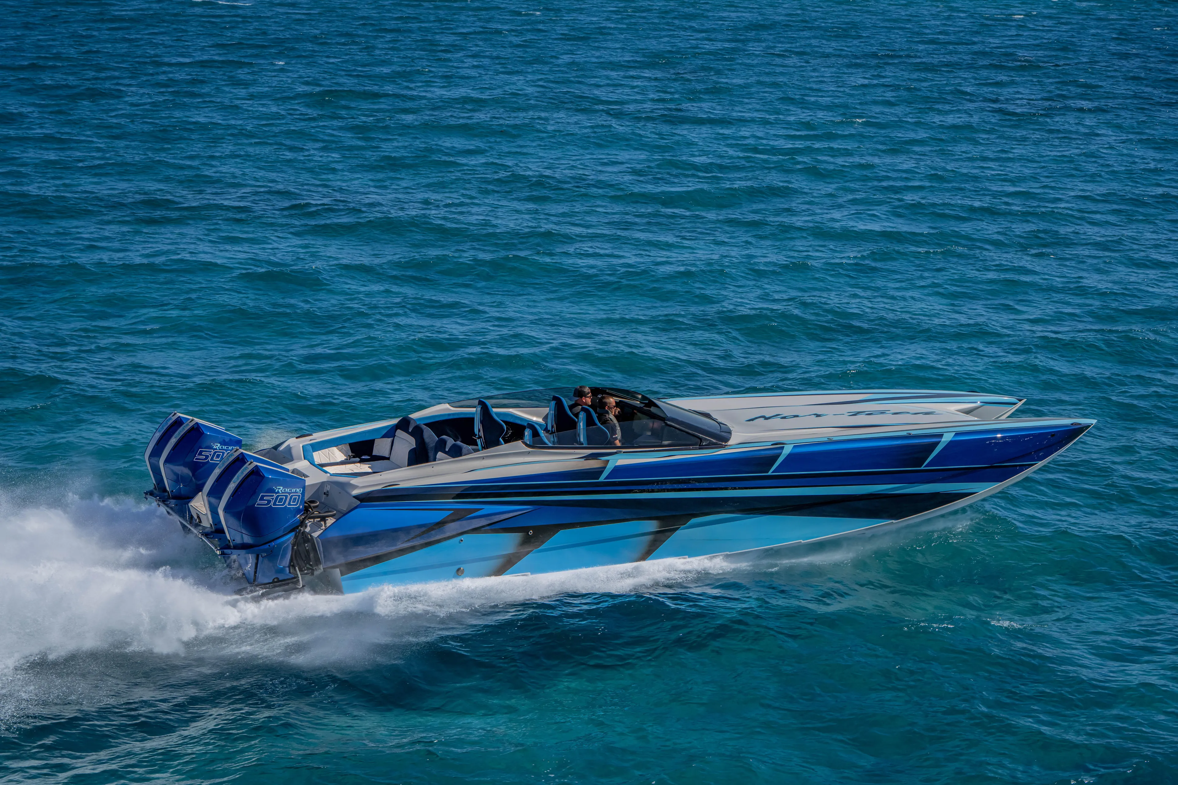  Yacht Photos Pics 2026 Nor-Tech 4000 Super Catamaran speeding on open water, showcasing sleek design and powerful engines.