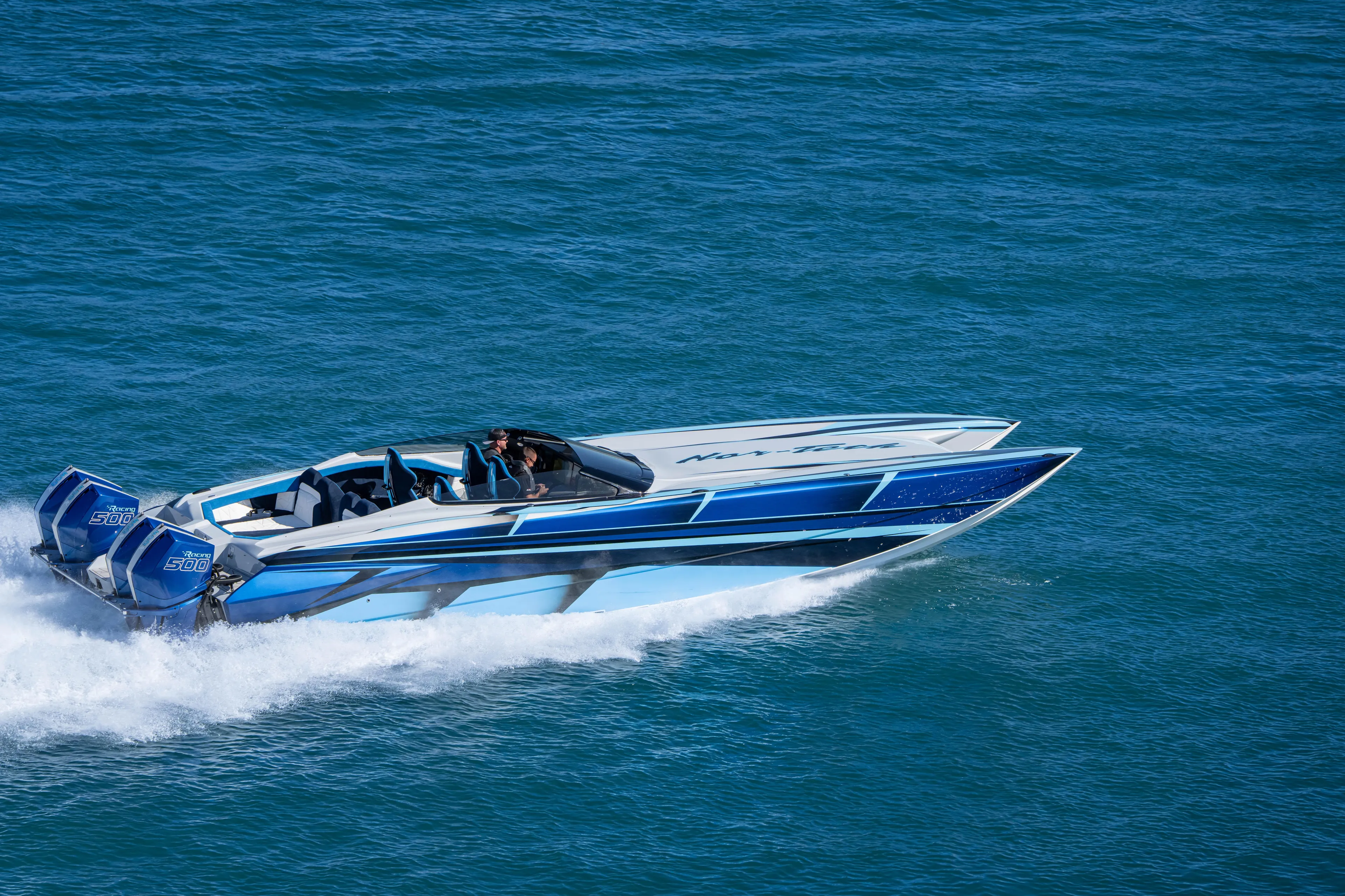  Yacht Photos Pics 2026 Nor-Tech 4000 Super Catamaran speeding on open water, showcasing sleek design.
