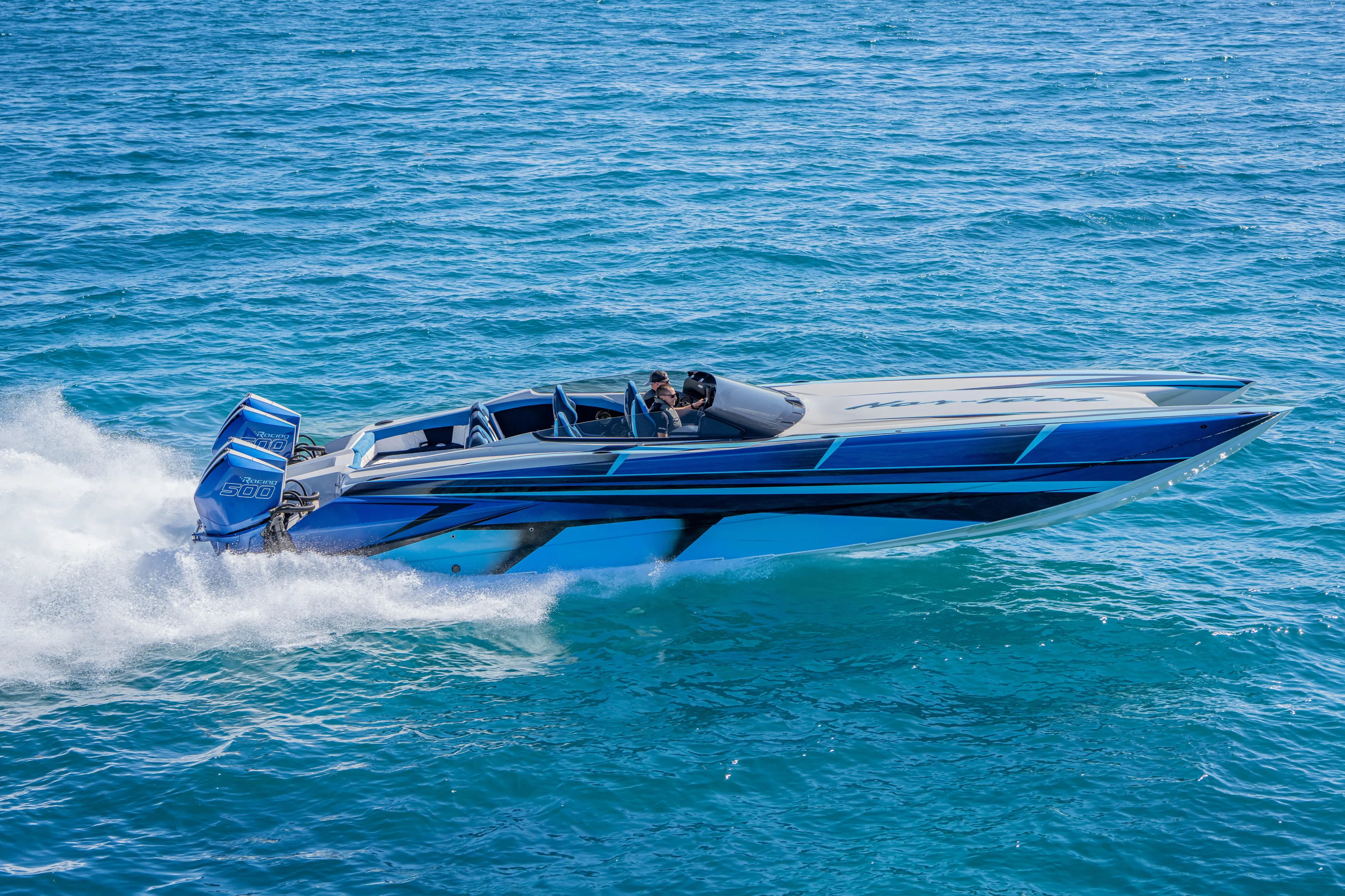  Yacht Photos Pics 2026 Nor-Tech 4000 Super Catamaran speeding on open water, showcasing sleek design.