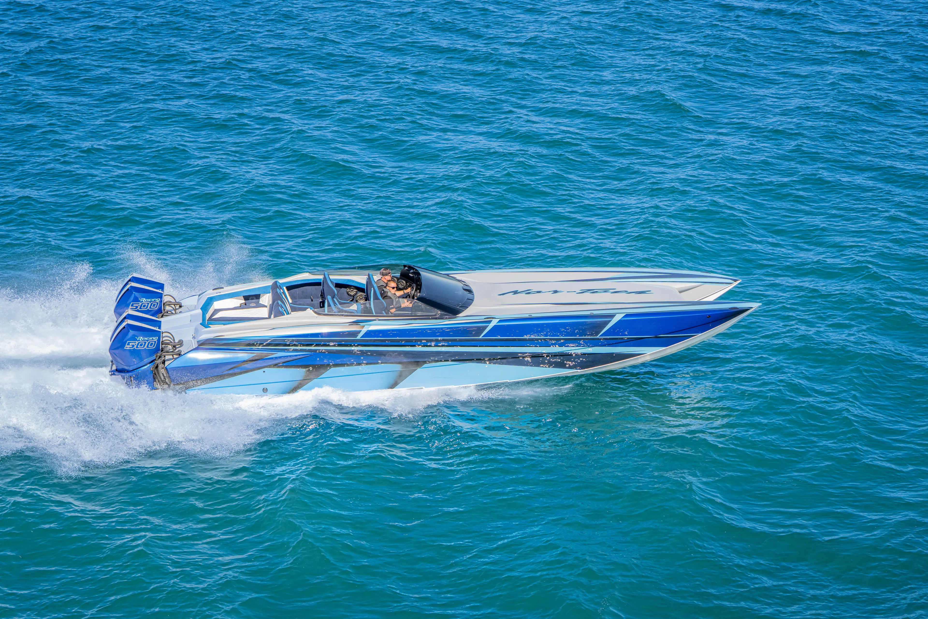  Yacht Photos Pics 2026 Nor-Tech 4000 Super Catamaran speeding on blue ocean waters.