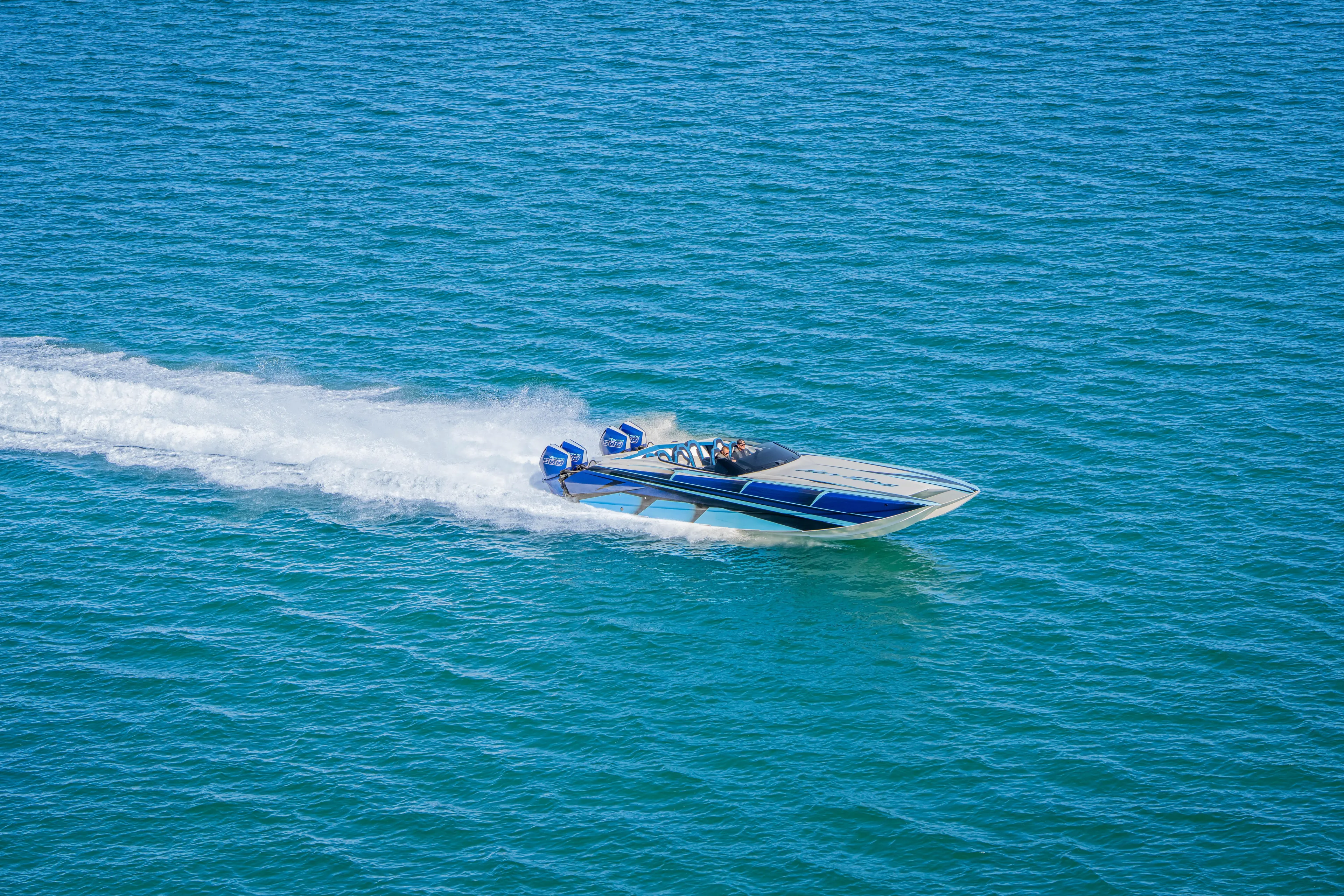  Yacht Photos Pics 2026 Nor-Tech 4000 Super Catamaran speeding on blue ocean waters.