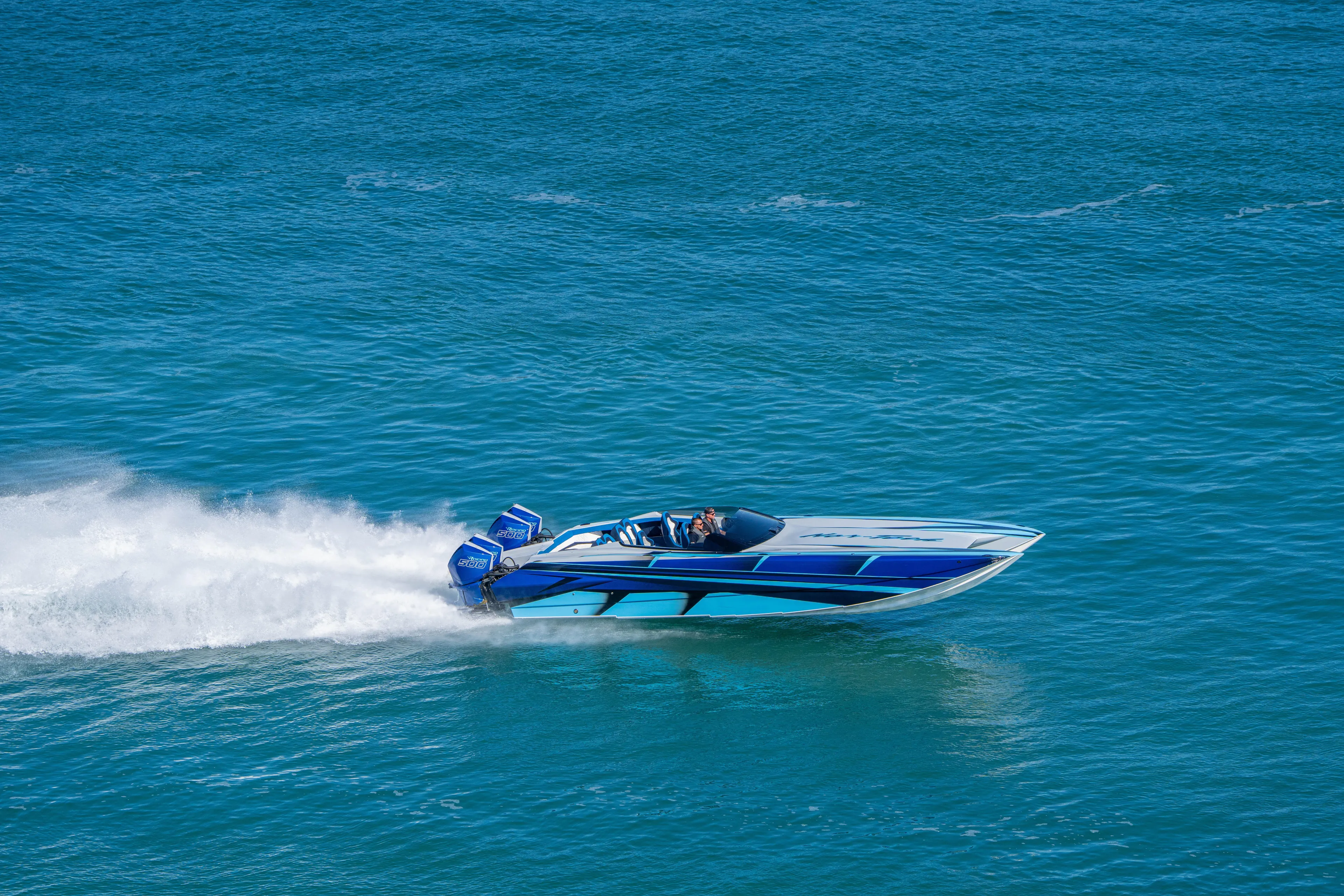  Yacht Photos Pics 2026 Nor-Tech 4000 Super Catamaran speeding on open water, showcasing sleek design.