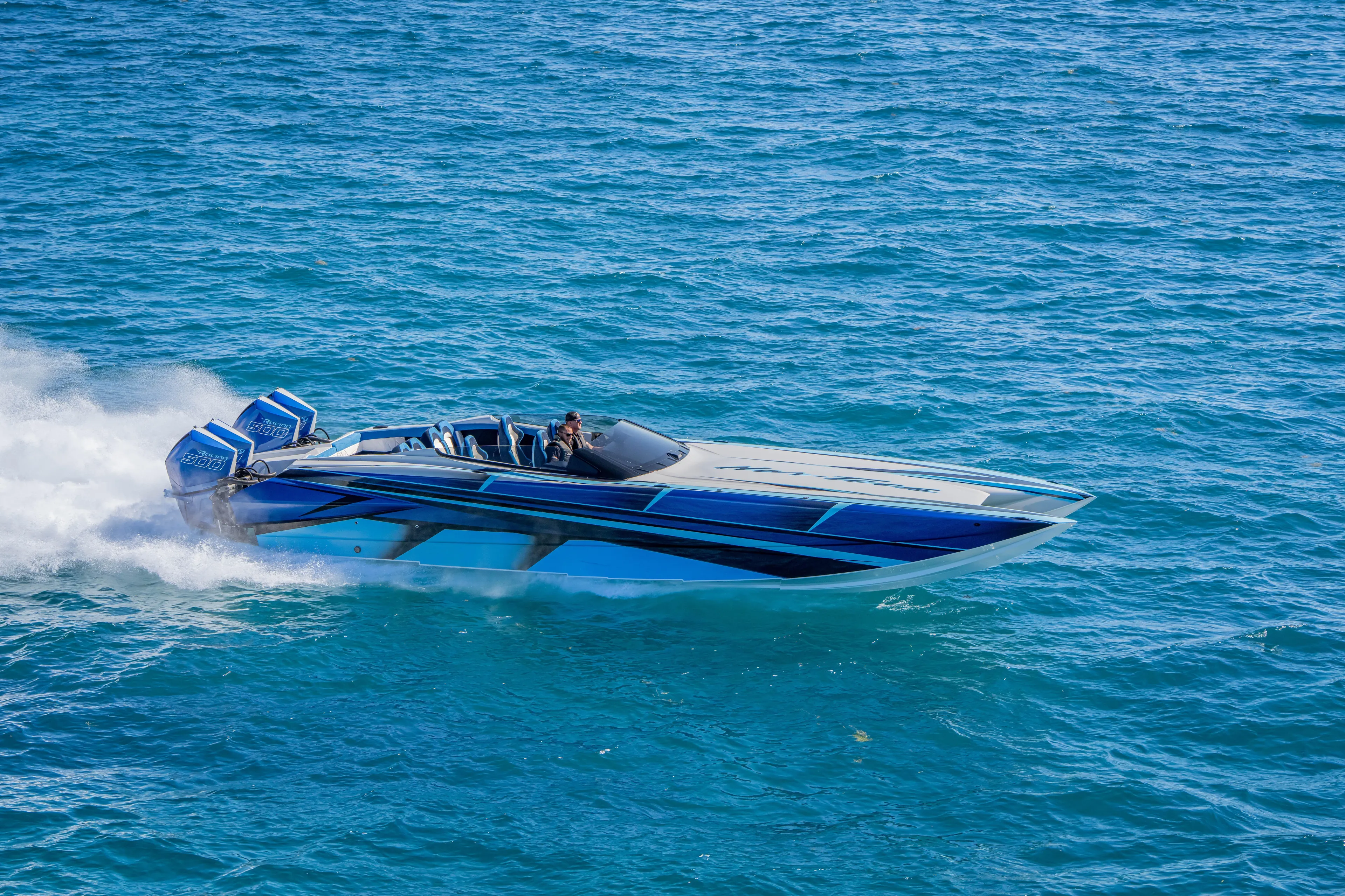  Yacht Photos Pics 2026 Nor-Tech 4000 Super Catamaran speeding on open water, showcasing sleek design.