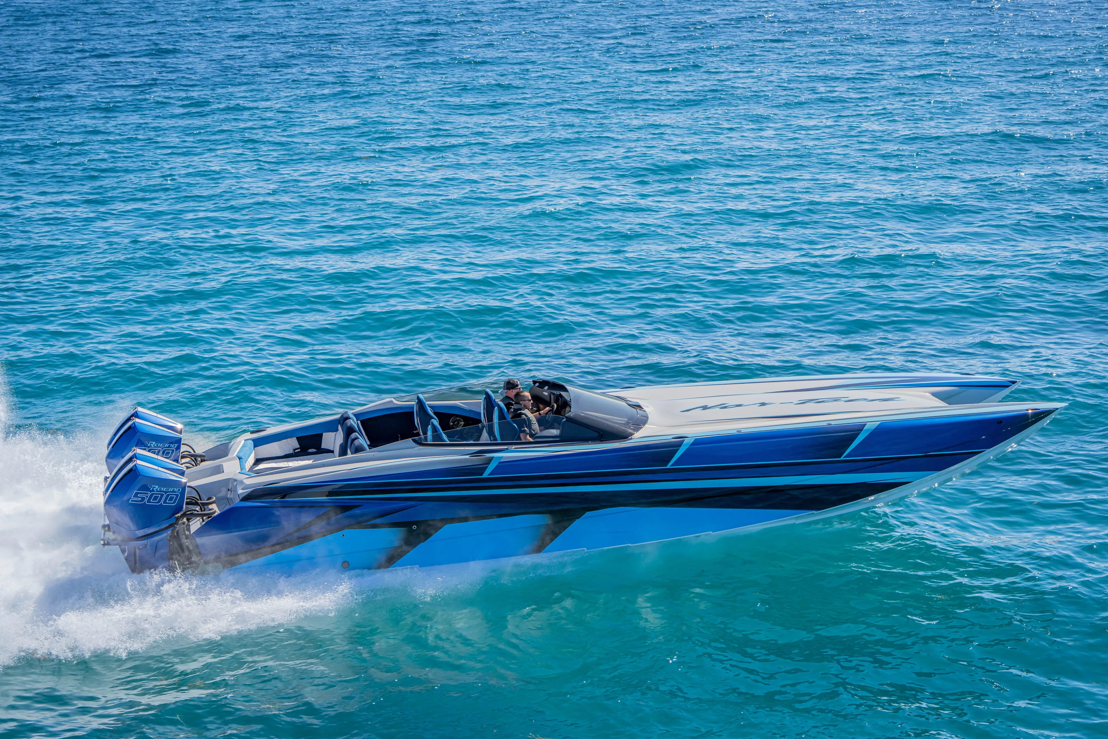  Yacht Photos Pics 2026 Nor-Tech 4000 Super Catamaran speeding on clear blue ocean waters.