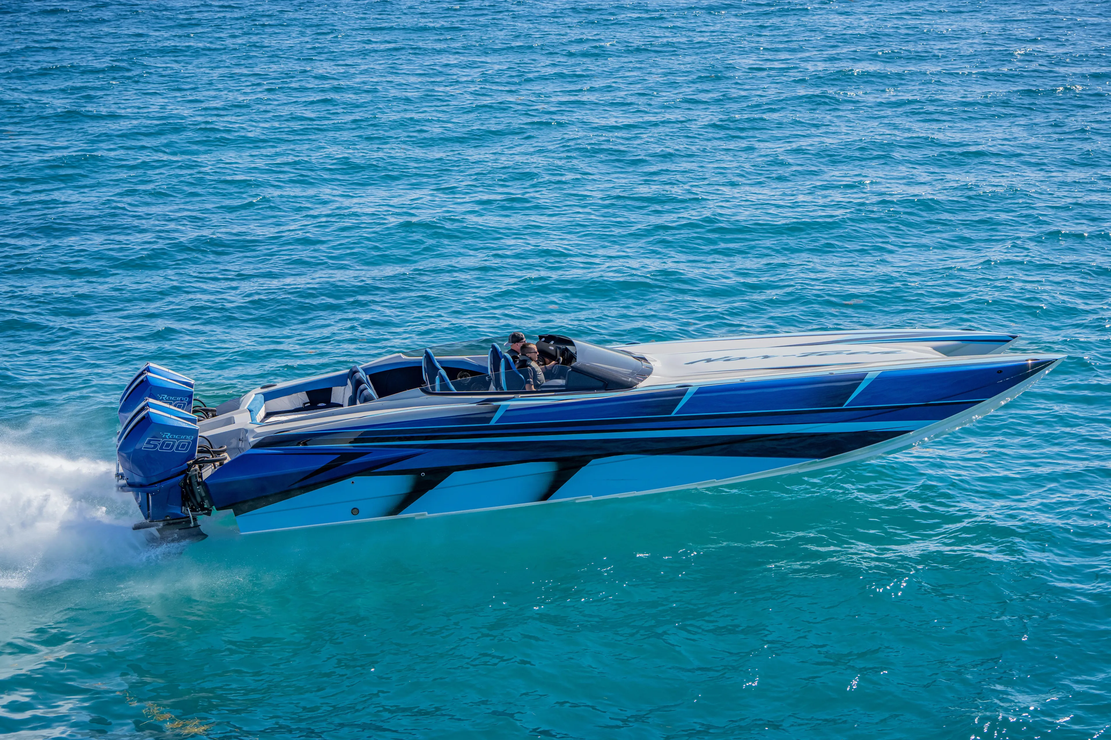  Yacht Photos Pics 2026 Nor-Tech 4000 Super Catamaran speeding on clear blue ocean waters.