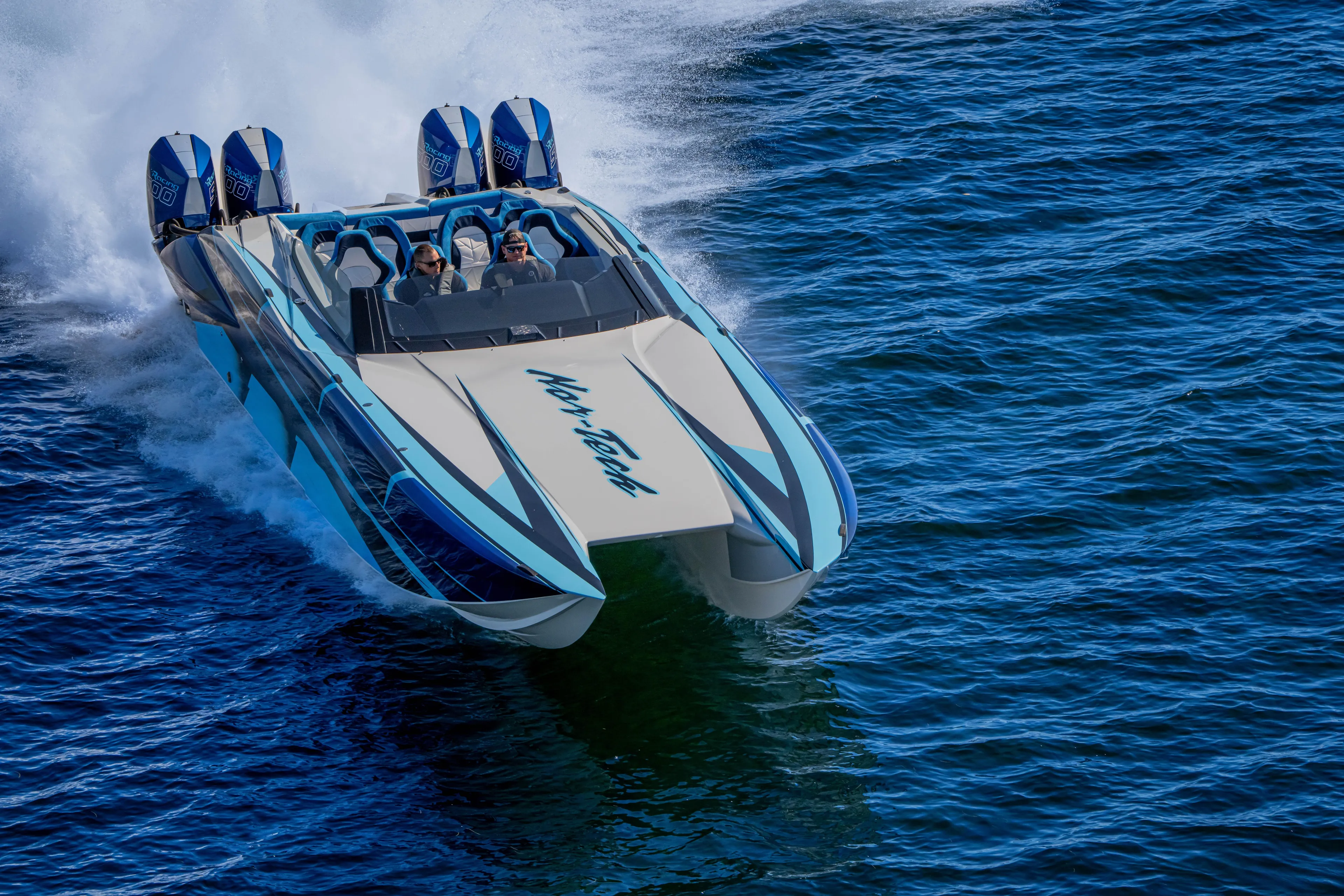  Yacht Photos Pics 2026 Nor-Tech 4000 Super Catamaran speeding on open water, showcasing sleek design and powerful engines.