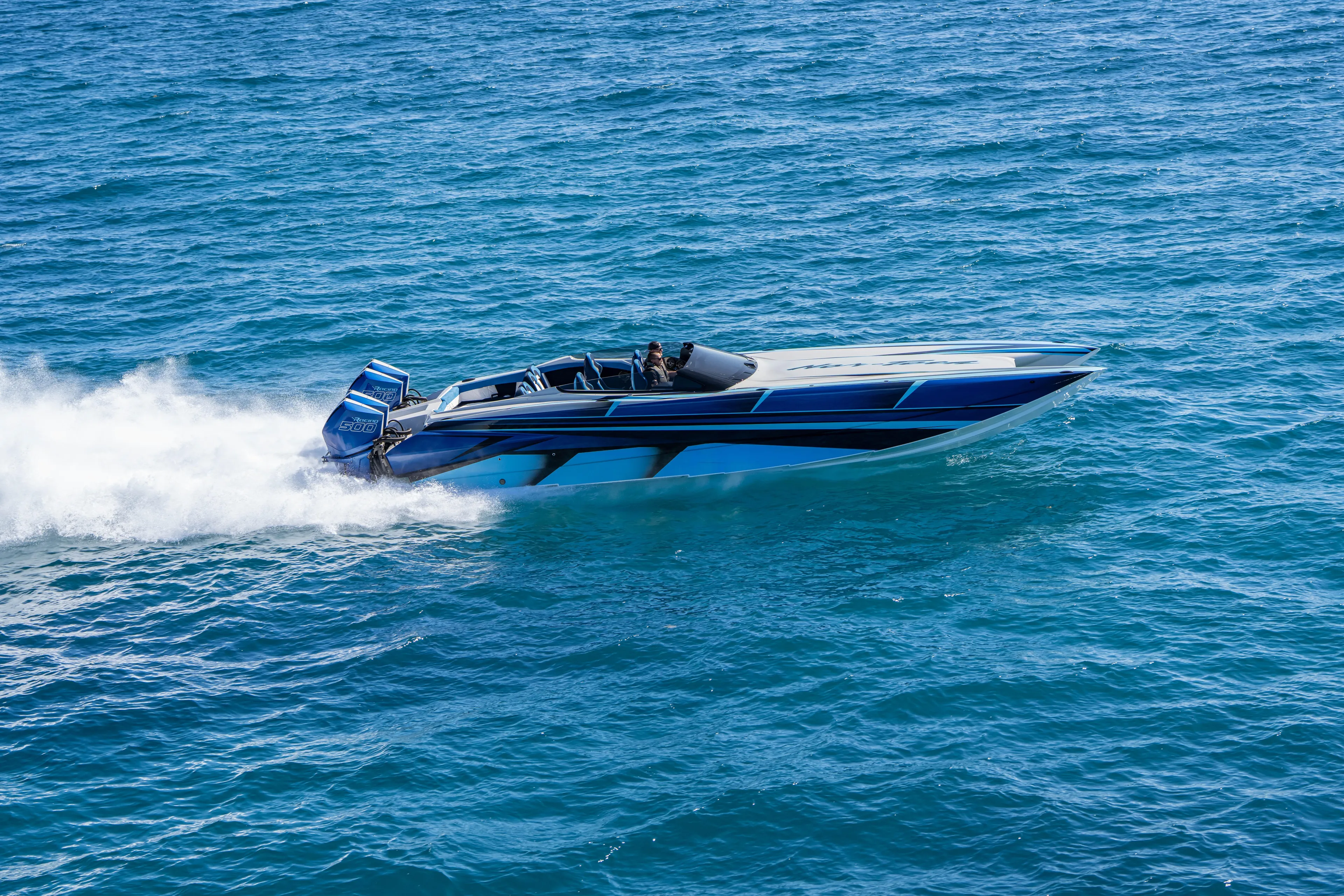  Yacht Photos Pics 2026 Nor-Tech 4000 Super Catamaran speeding on open water, showcasing sleek design and power.
