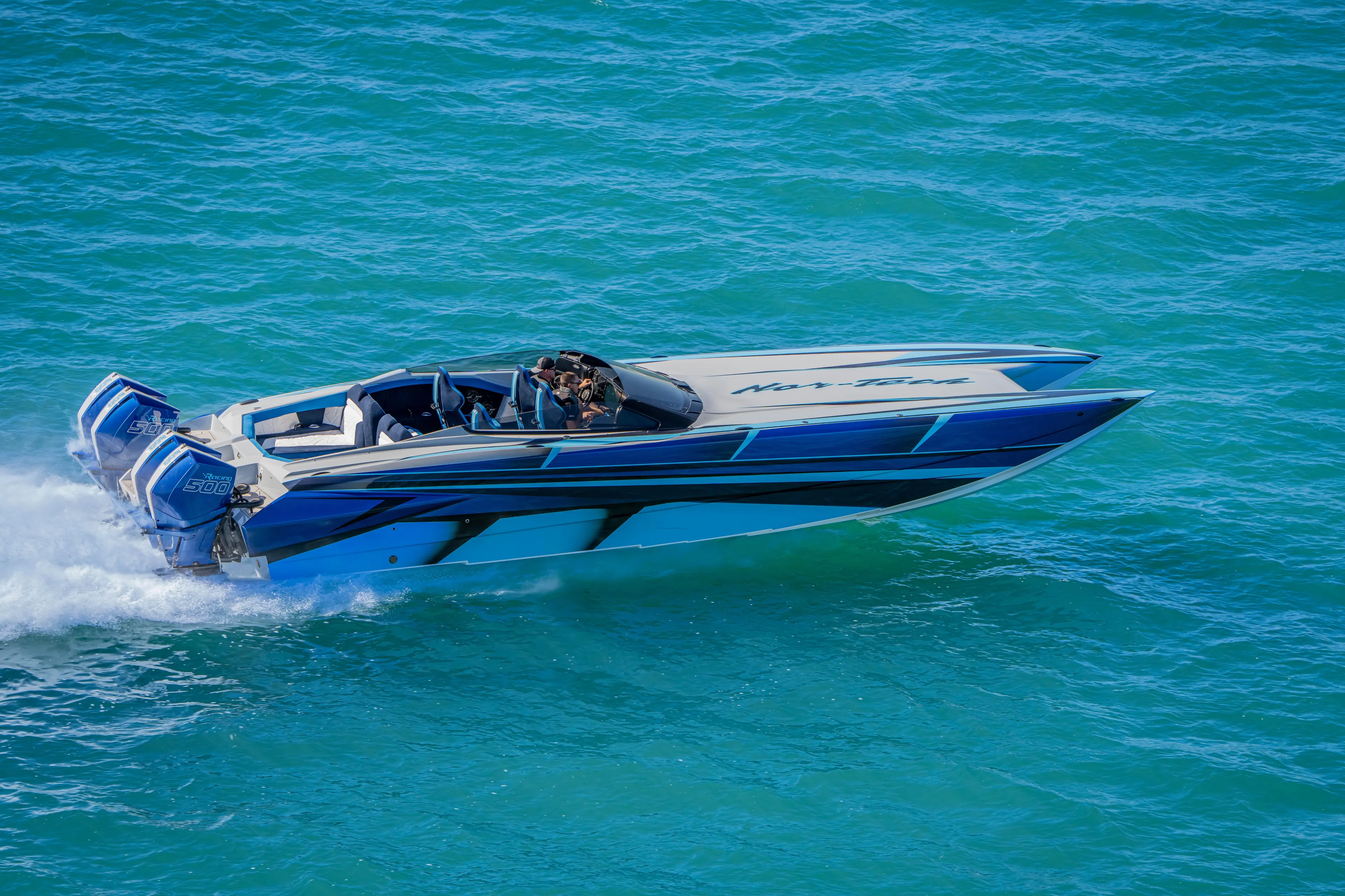  Yacht Photos Pics 2026 Nor-Tech 4000 Super Catamaran speeding on blue ocean waters.