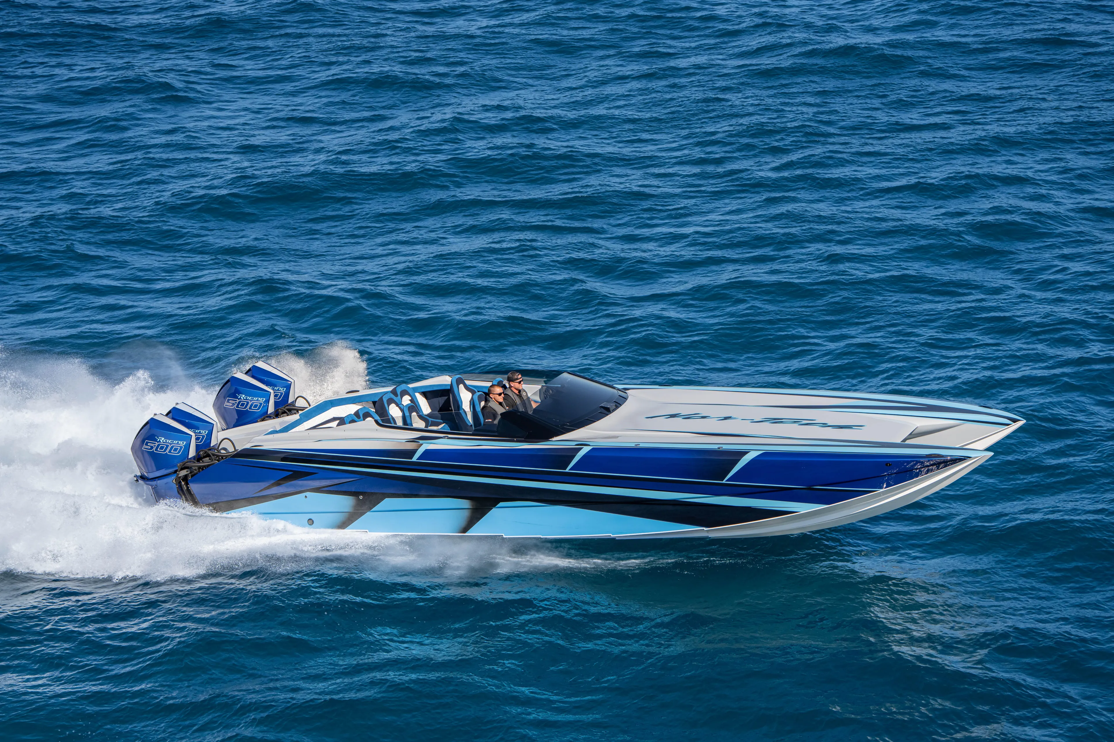  Yacht Photos Pics 2026 Nor-Tech 4000 Super Catamaran speeding on open water, showcasing sleek design and powerful engines.