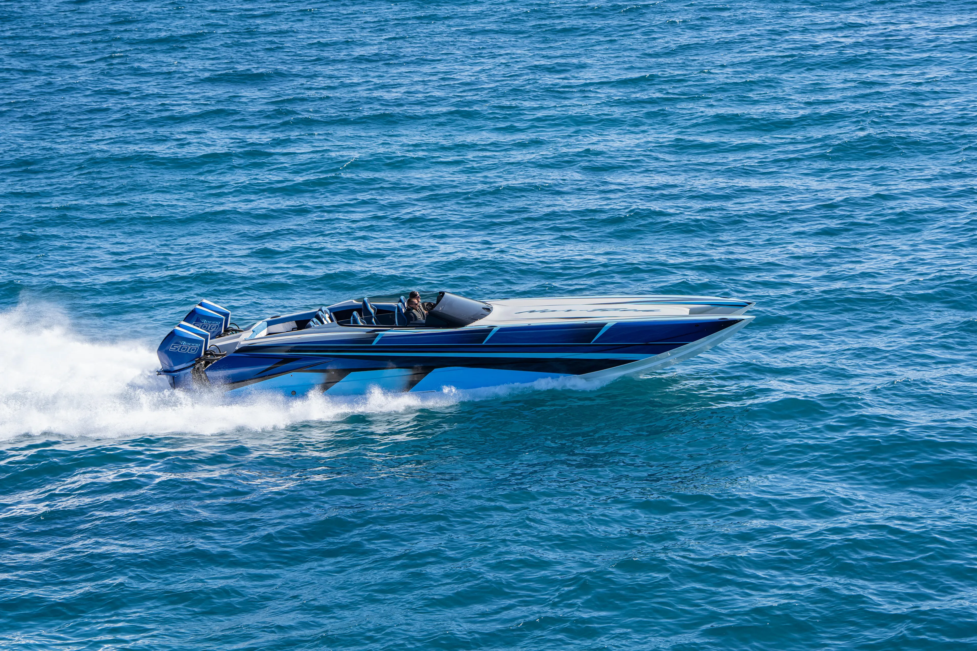  Yacht Photos Pics 2026 Nor-Tech 4000 Super Catamaran speeding on open water, showcasing sleek design.
