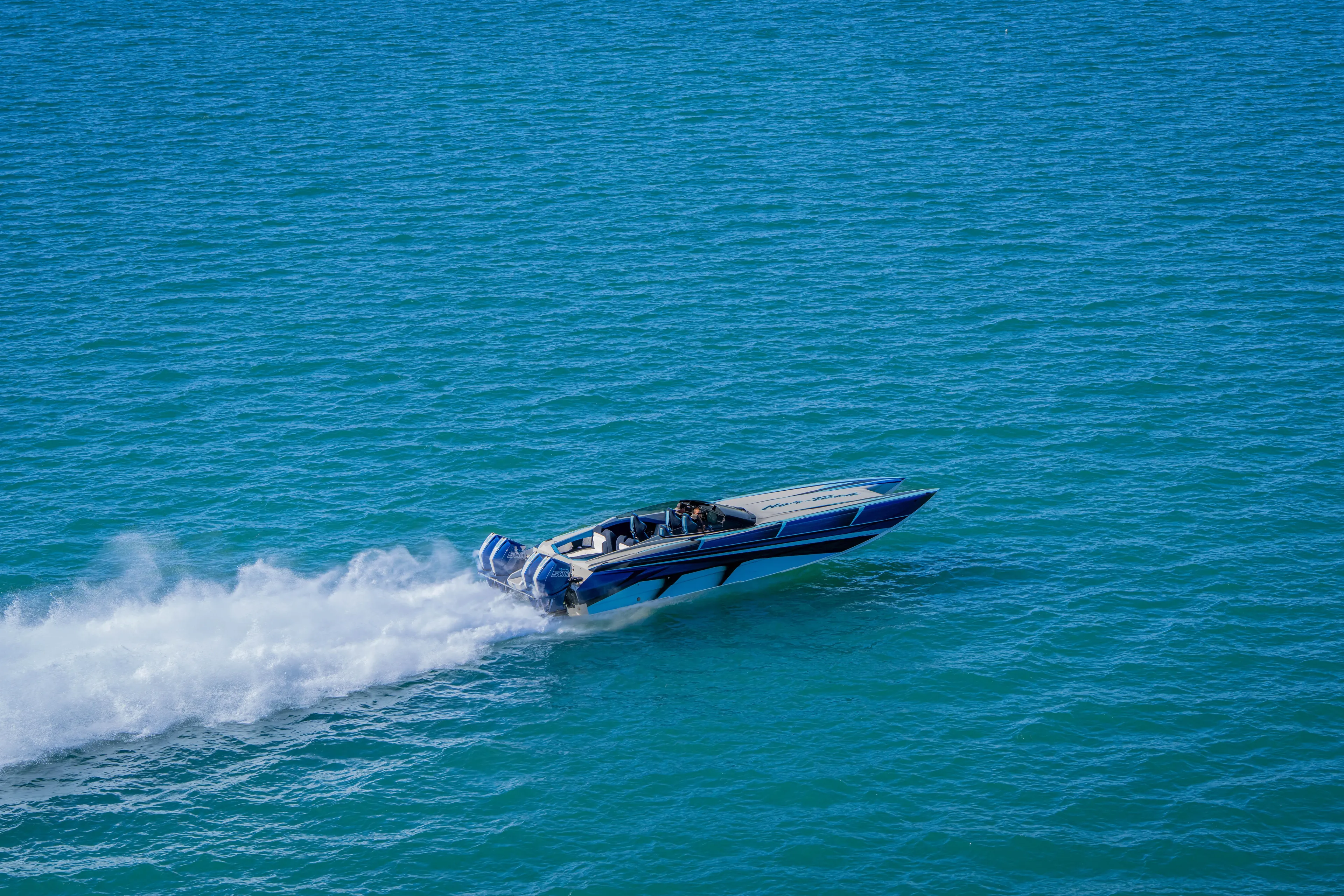  Yacht Photos Pics 2026 Nor-Tech 4000 Super Catamaran speeding on open blue water.
