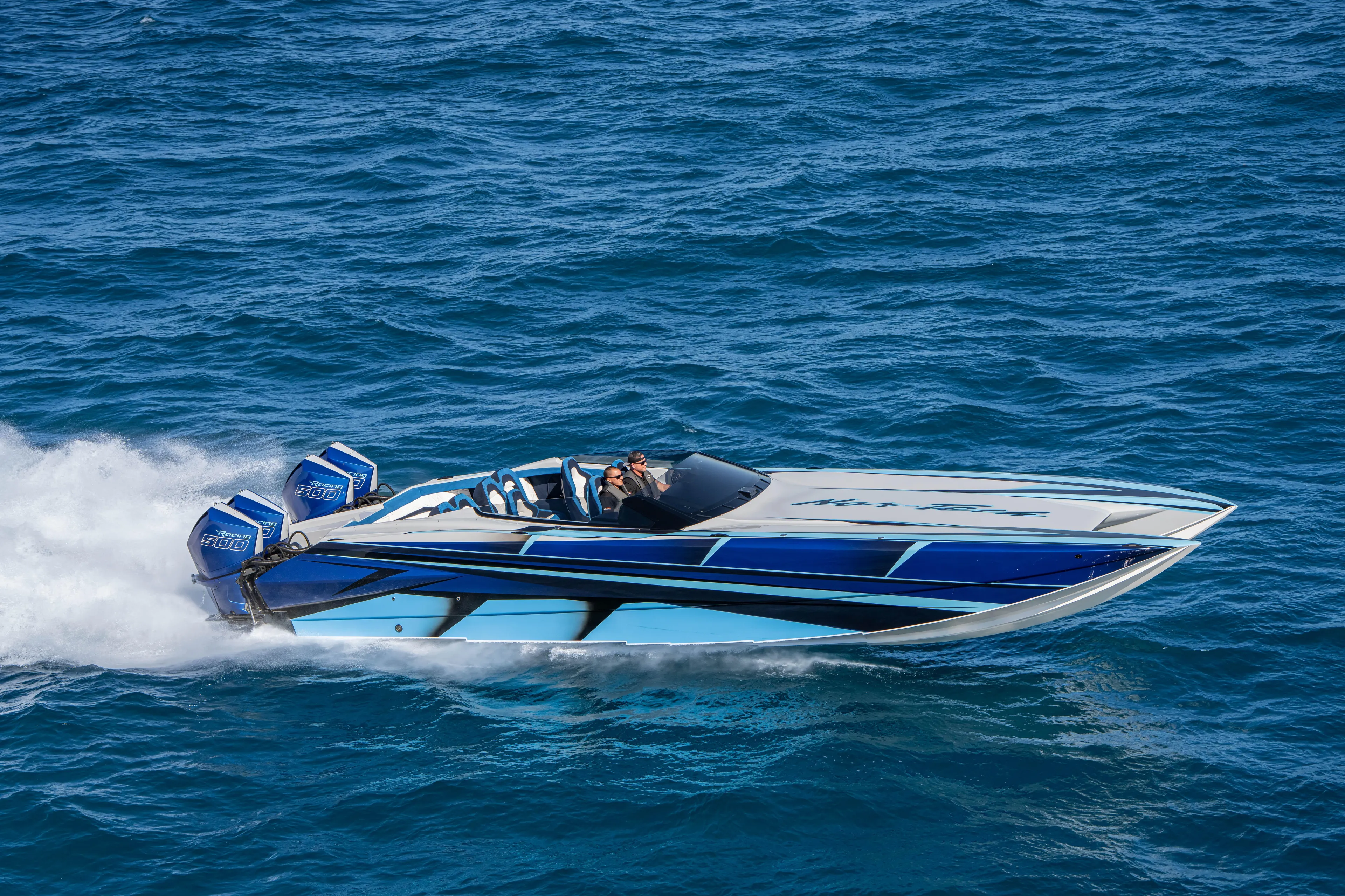  Yacht Photos Pics 2026 Nor-Tech 4000 Super Catamaran speeding on open water, showcasing sleek design.
