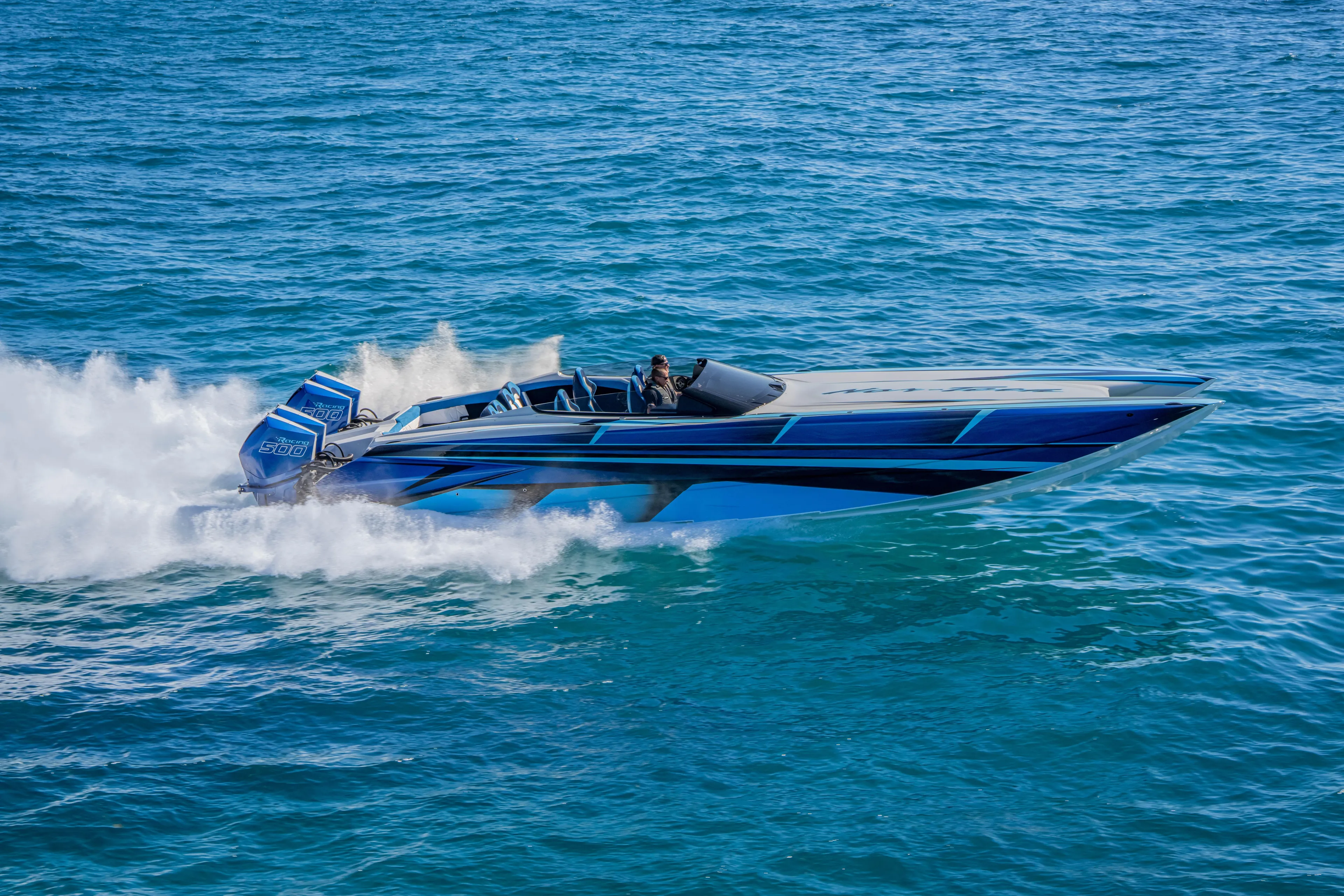 Yacht Photos Pics 2026 Nor-Tech 4000 Super Catamaran speeding on open water, showcasing sleek design.