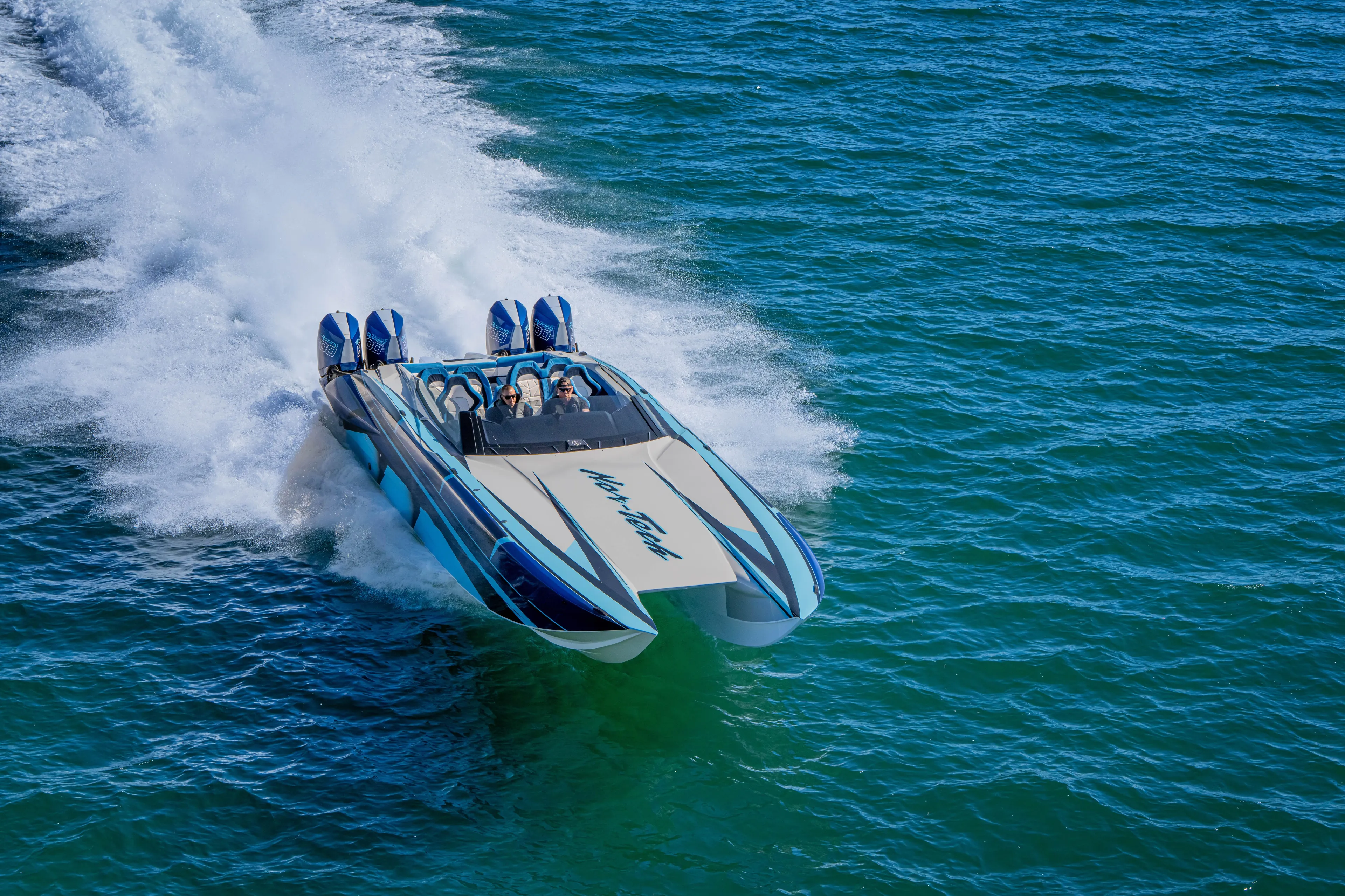  Yacht Photos Pics 2026 Nor-Tech 4000 Super Catamaran speeding on open water, showcasing sleek design.