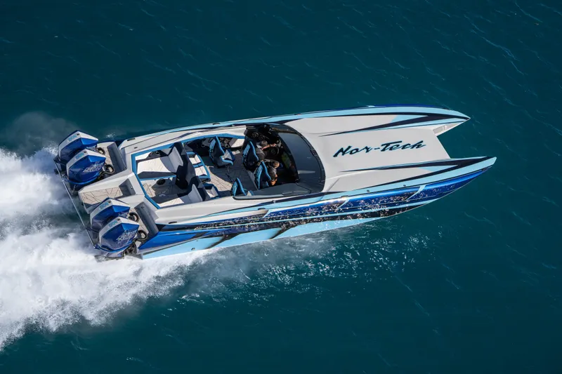  Yacht Photos Pics 2026 Nor-Tech 4000 Super Catamaran speeding on blue ocean waters.