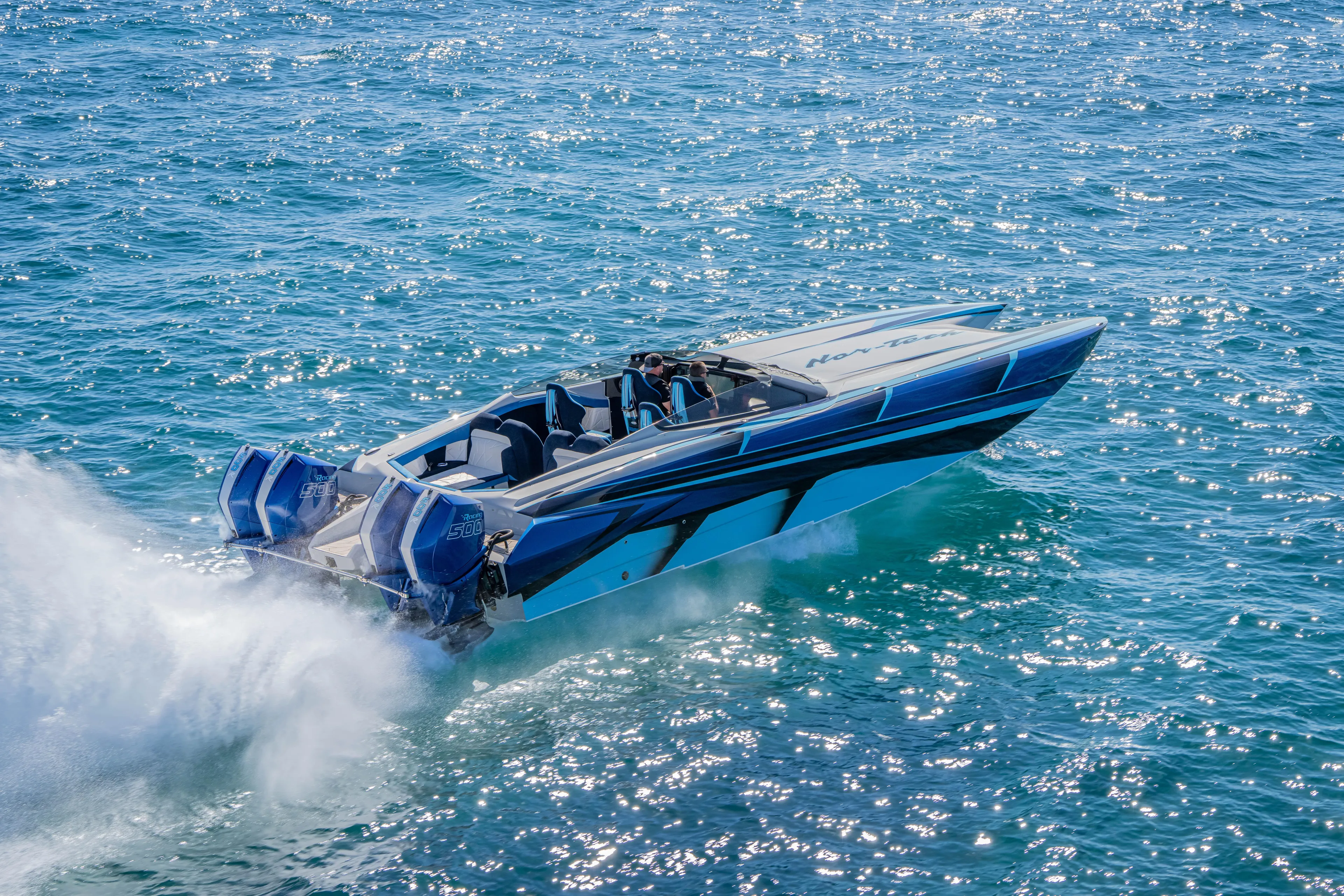  Yacht Photos Pics 2026 Nor-Tech 4000 Super Catamaran speeding on sparkling blue water.