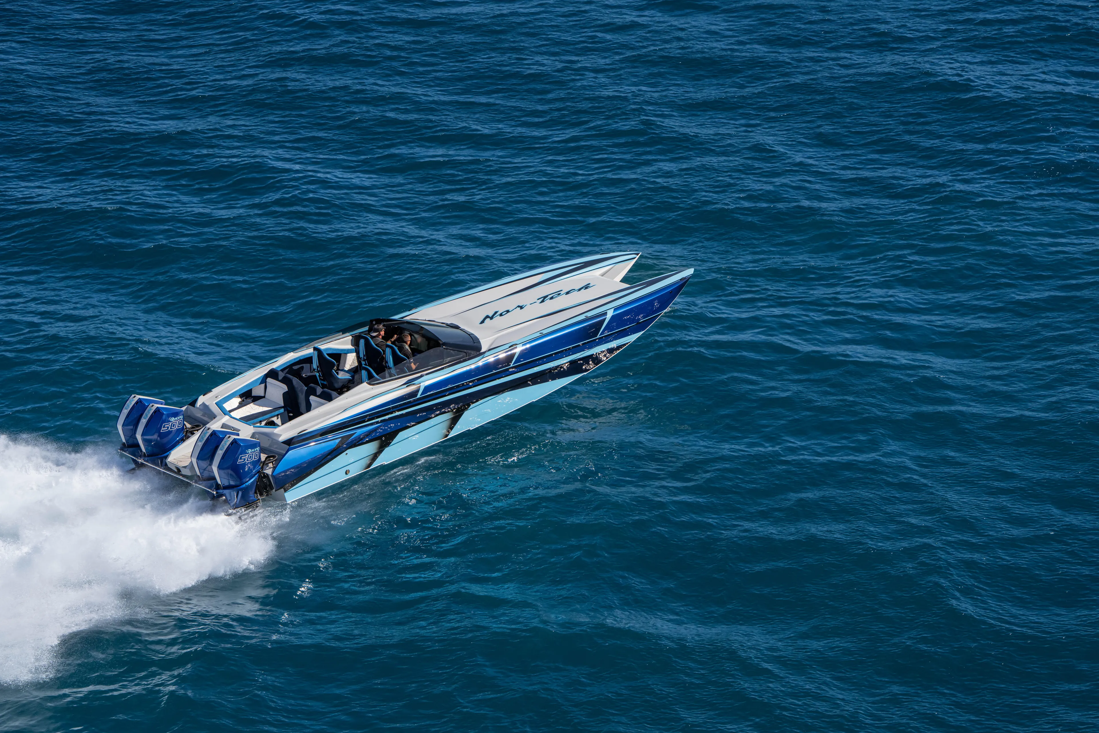  Yacht Photos Pics 2026 Nor-Tech 4000 Super Catamaran speeding on open water, showcasing sleek design and power.