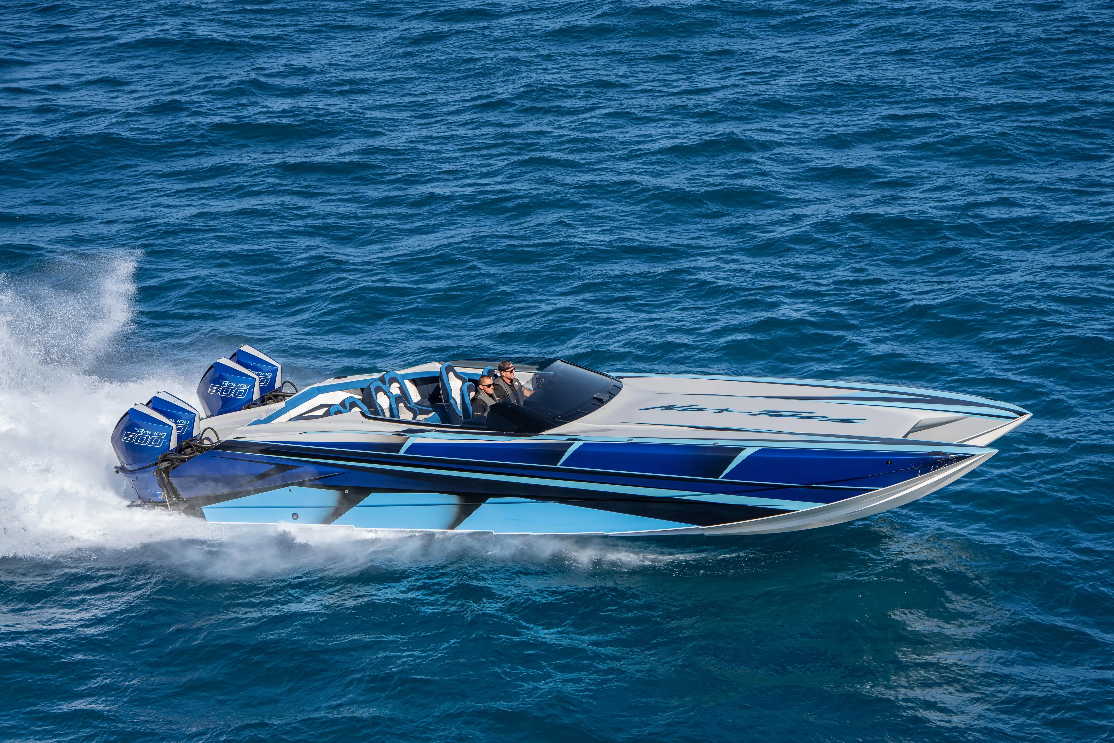  Yacht Photos Pics 2026 Nor-Tech 4000 Super Catamaran speeding on open water, showcasing sleek design and powerful engines.