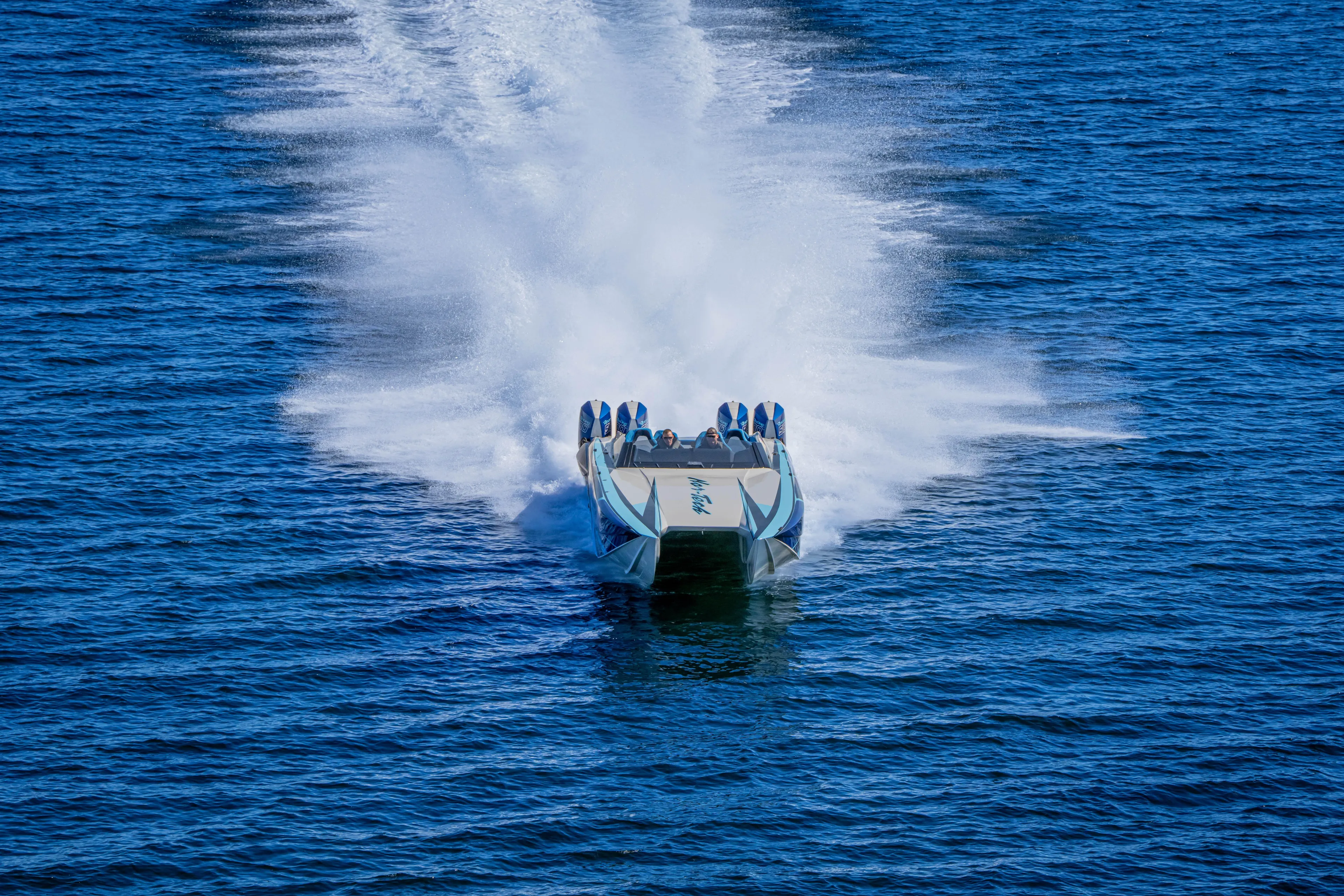  Yacht Photos Pics 2026 Nor-Tech 4000 Super Catamaran speeding on open water, creating a dramatic wake.