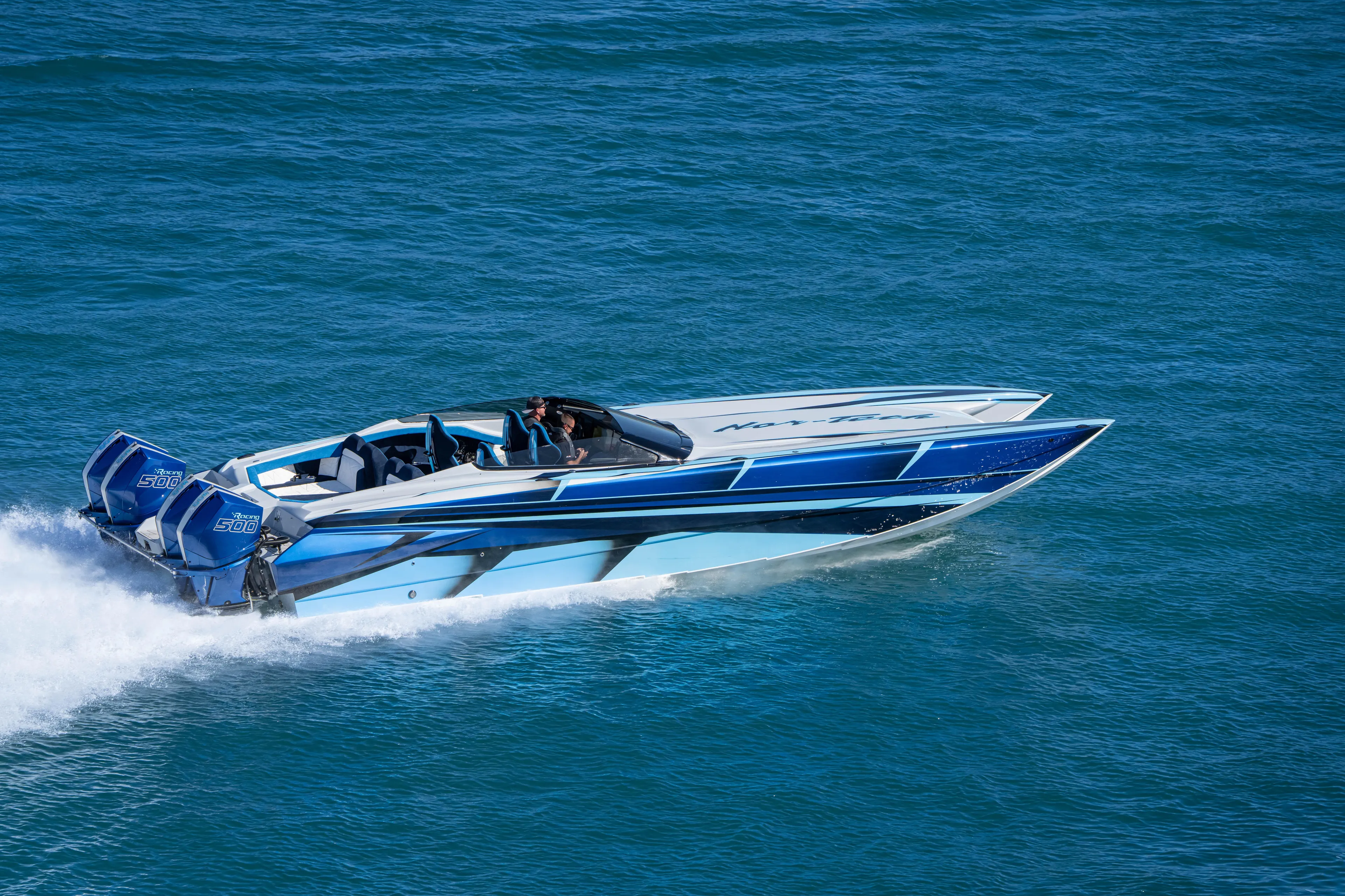  Yacht Photos Pics 2026 Nor-Tech 4000 Super Catamaran speeding on blue ocean waters.