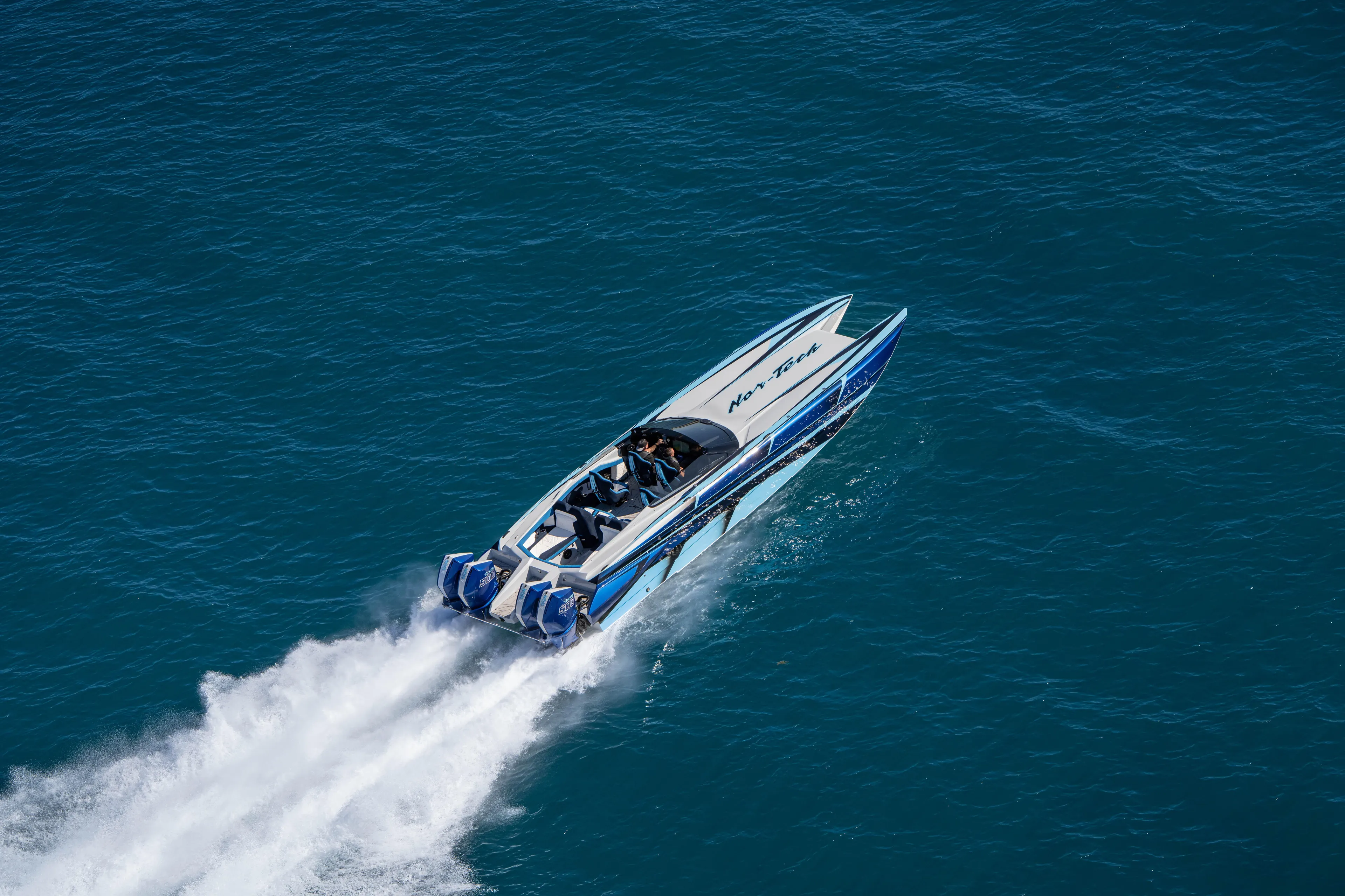  Yacht Photos Pics 2026 Nor-Tech 4000 Super Catamaran speeding on open water, showcasing sleek design.