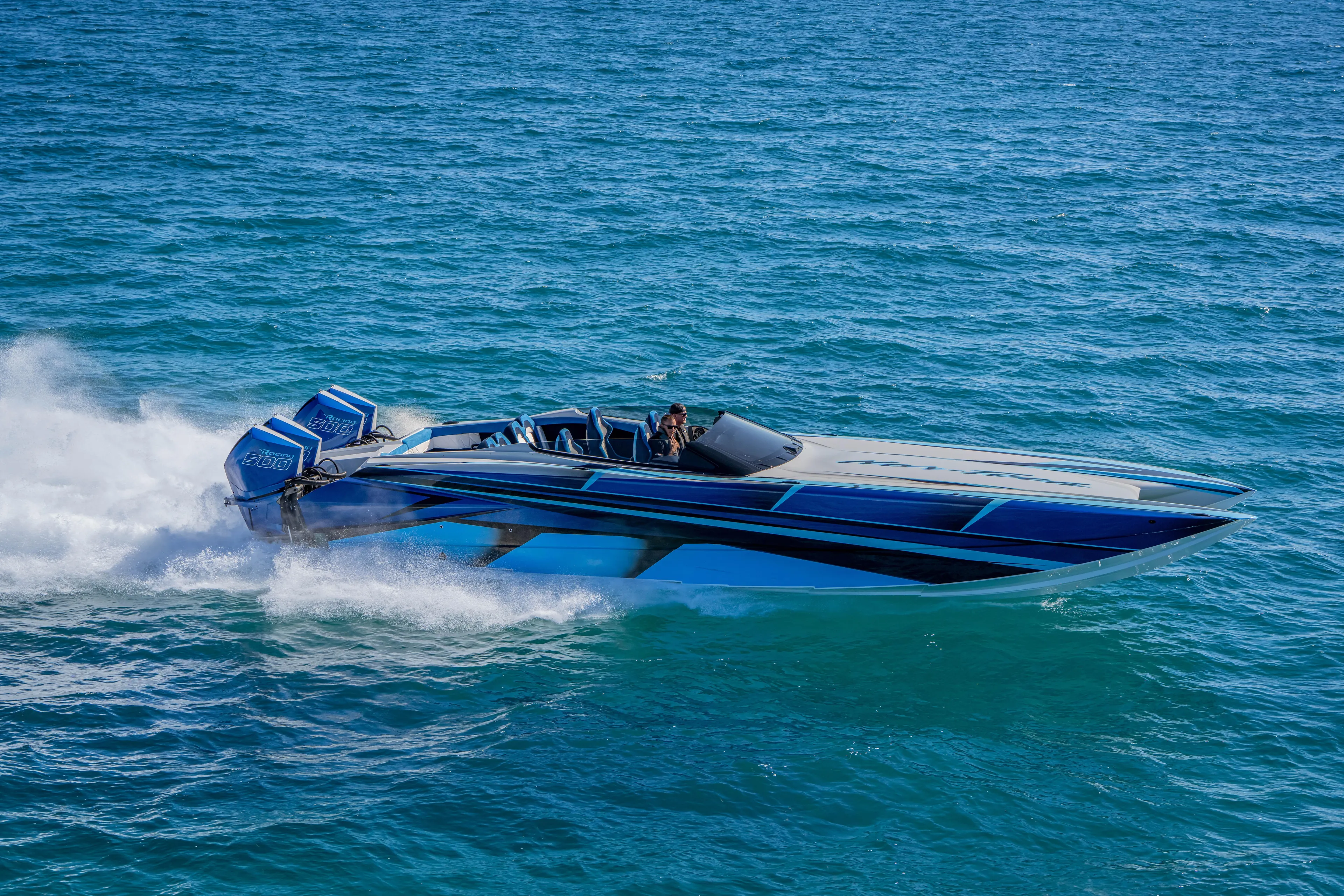 Yacht Photos Pics 2026 Nor-Tech 4000 Super Catamaran speeding on open water, showcasing sleek design and power.