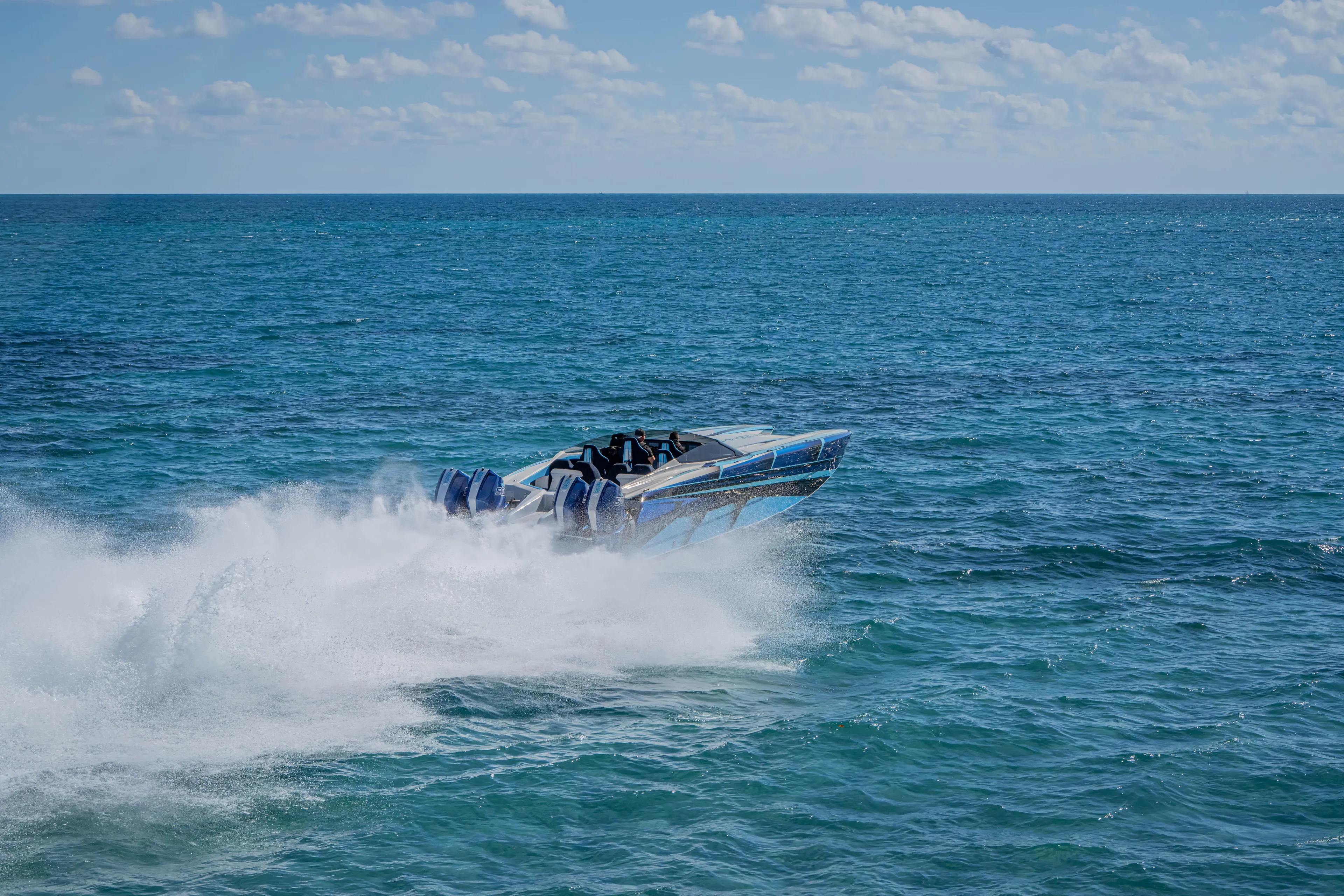  Yacht Photos Pics 2026 Nor-Tech 4000 Super Catamaran speeding across ocean waves under clear sky.