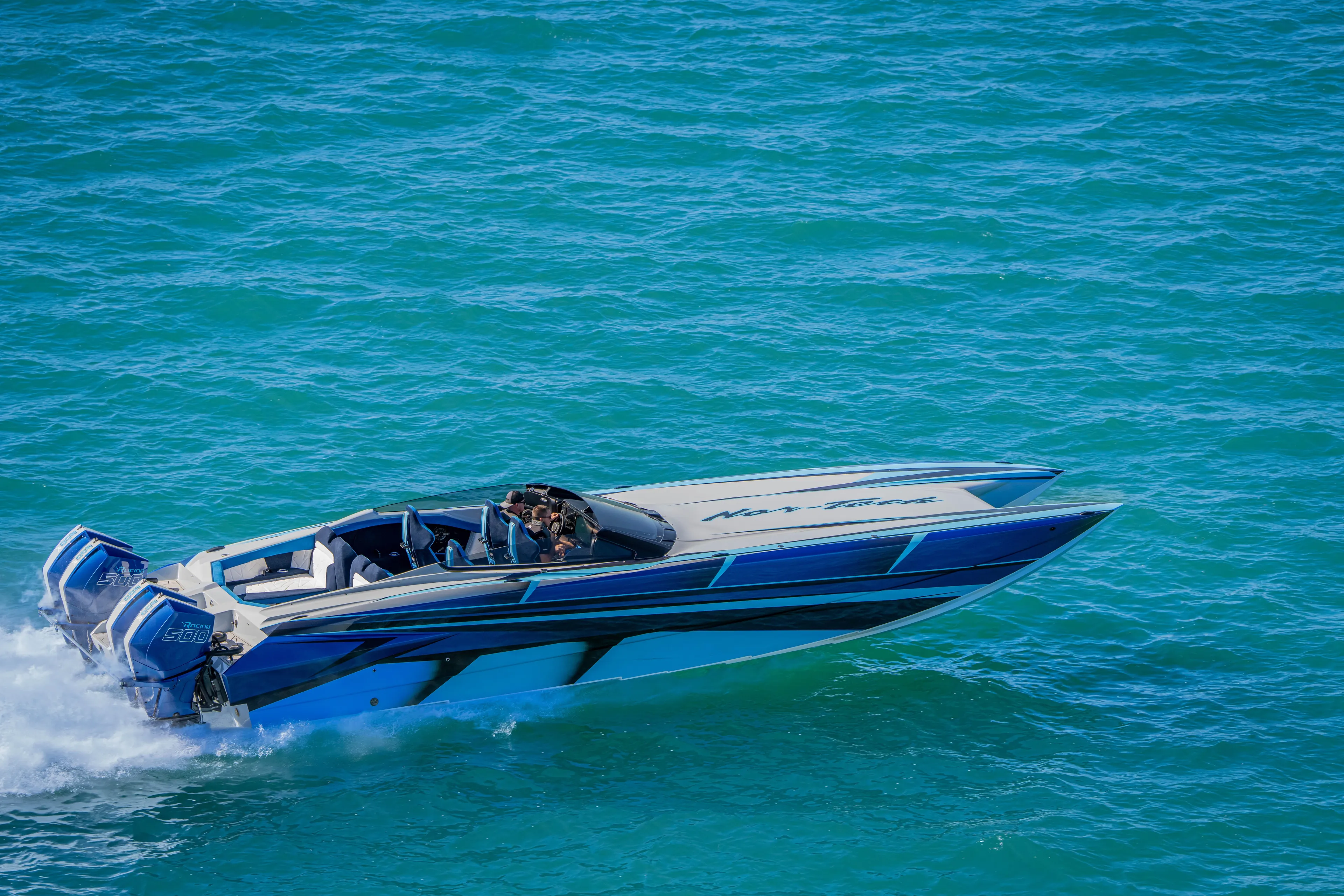  Yacht Photos Pics 2026 Nor-Tech 4000 Super Catamaran speeding on blue ocean waters.