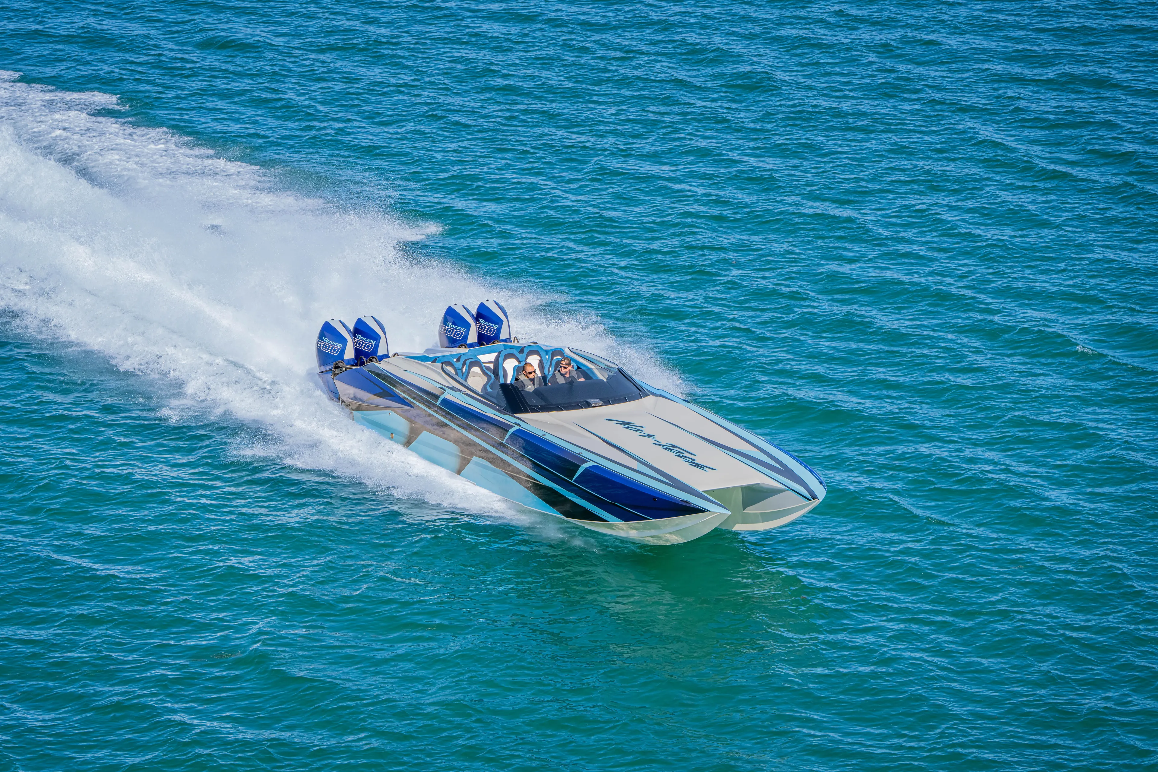  Yacht Photos Pics 2026 Nor-Tech 4000 Super Catamaran speeding on open water, showcasing sleek design and power.