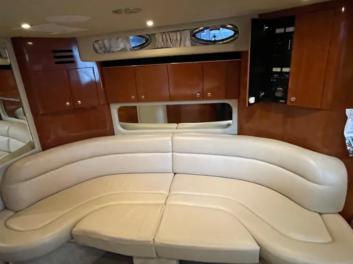  Yacht Photos Pics Interior of 2003 Sea Ray 380 Sundancer with beige leather seating and wooden cabinets.