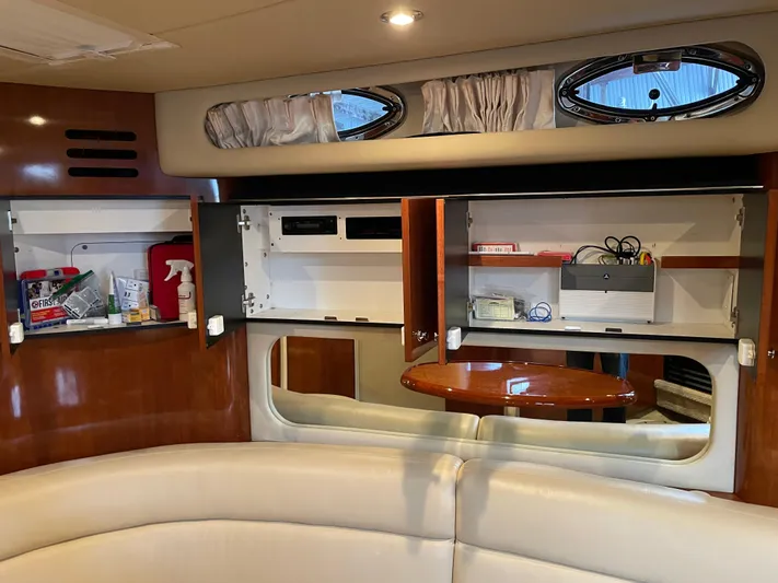  Yacht Photos Pics Interior of 2003 Sea Ray 380 Sundancer with open cabinets and seating area.
