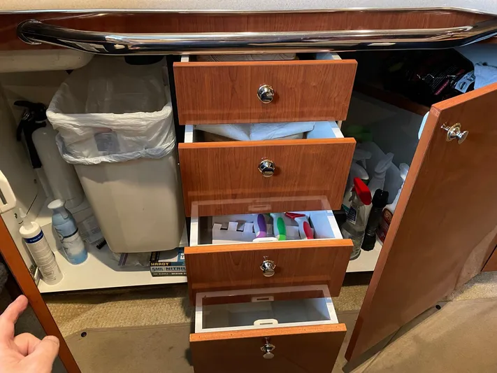  Yacht Photos Pics Open cabinet with drawers and cleaning supplies on a 2003 Sea Ray 380 Sundancer boat.