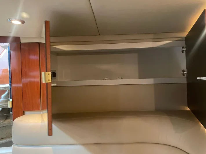  Yacht Photos Pics Open cabinet inside 2003 Sea Ray 380 Sundancer yacht, featuring wooden doors and beige interior.