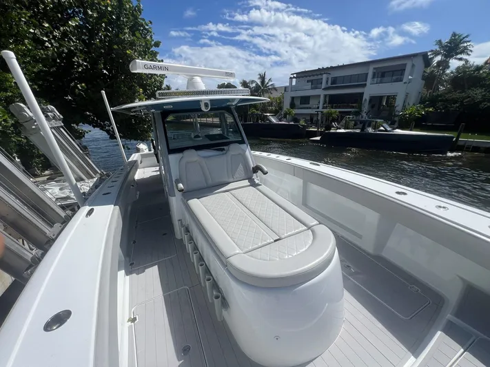 Nomad Yacht Photos Pics 2021 Freeman 42 LR boat with Garmin equipment, docked near waterfront property.