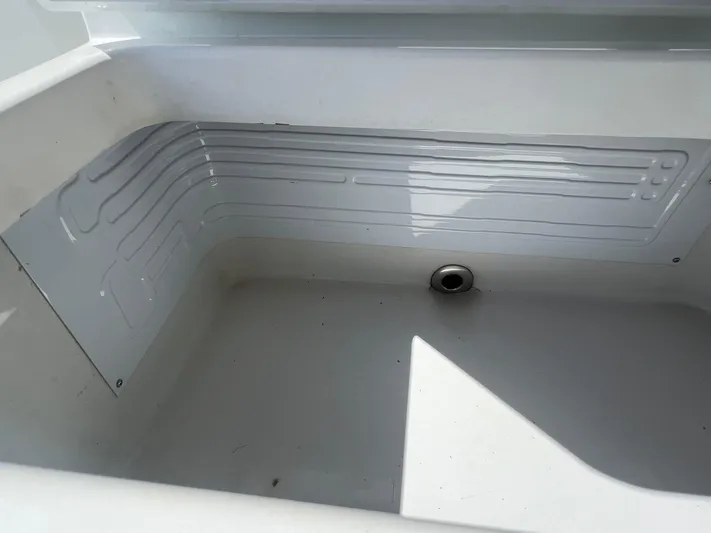 Nomad Yacht Photos Pics Freeman 42 LR 2021 boat storage compartment with drainage hole.